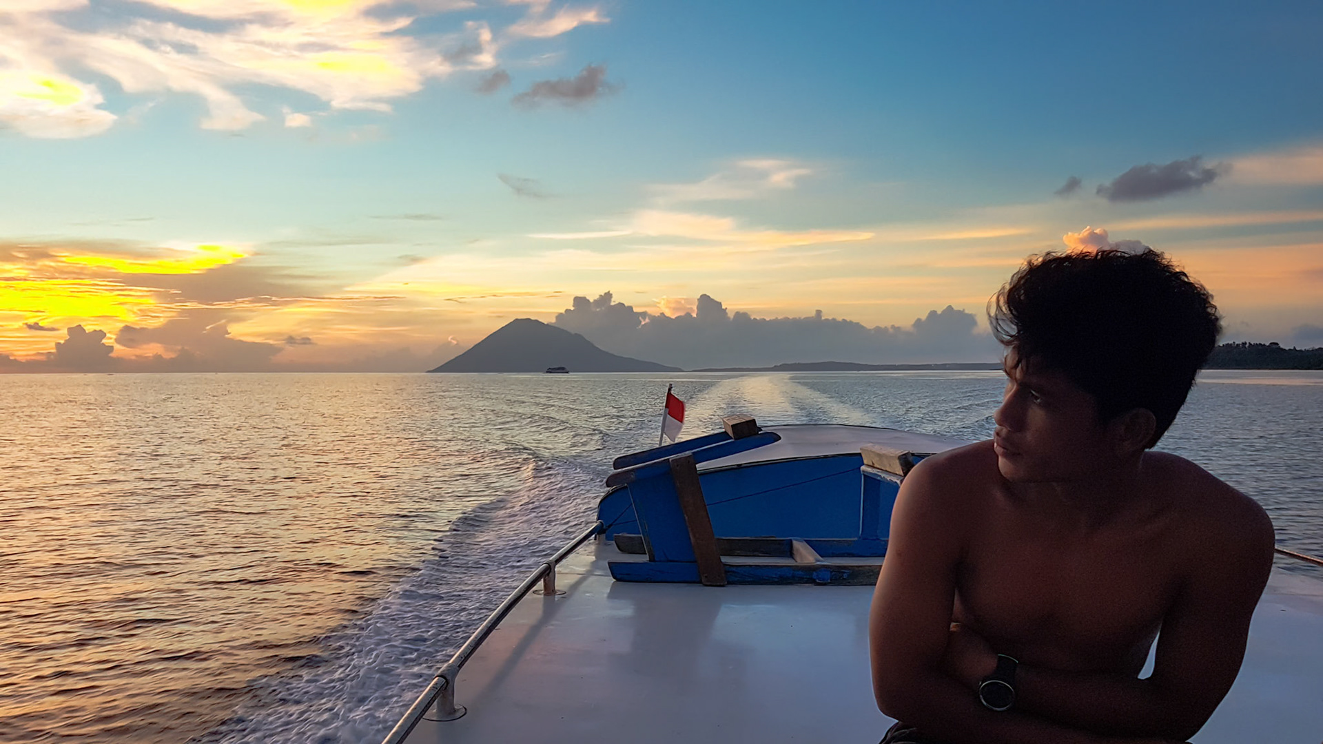 The boat ride back from Bangka Island was a dream, with the sun setting behind an old volcano.