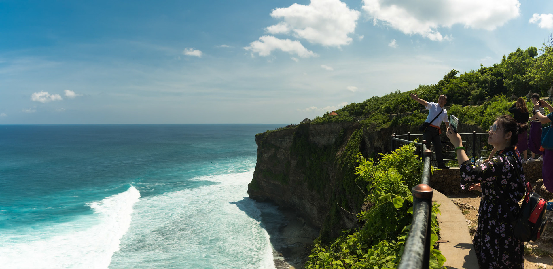 Lots of tourists taking photos of themselves at the temple on the cliffs at Uluawatu on the south end of Bali.