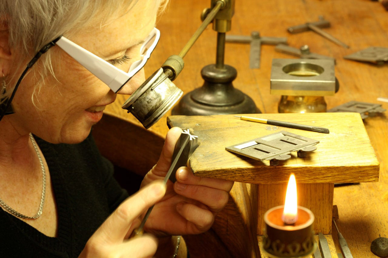 Engraving a punch by Nelly Gable, master craftsman.