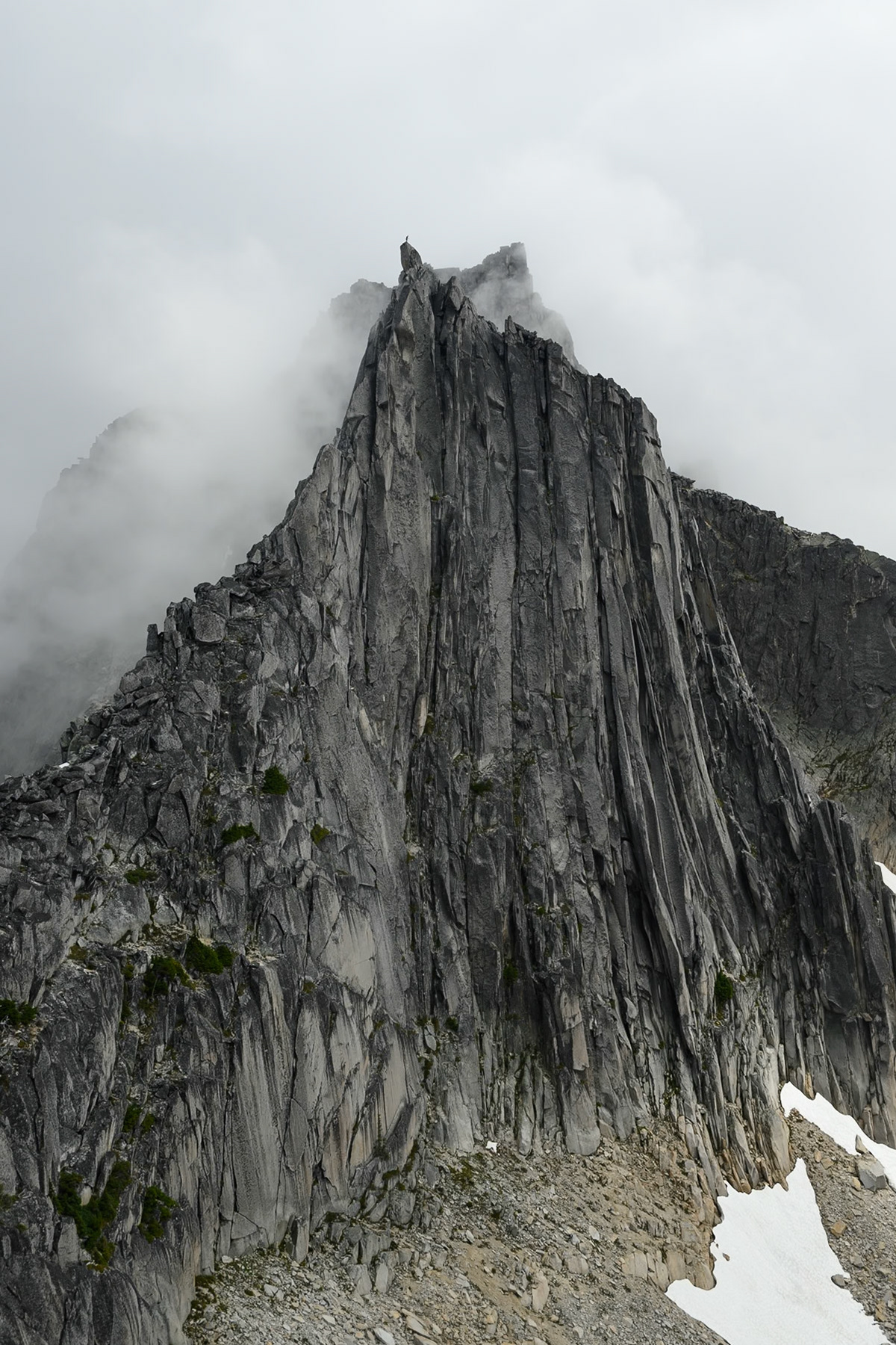 Top of the climb looking at North Nesakwatch Spire with a climber on the top.