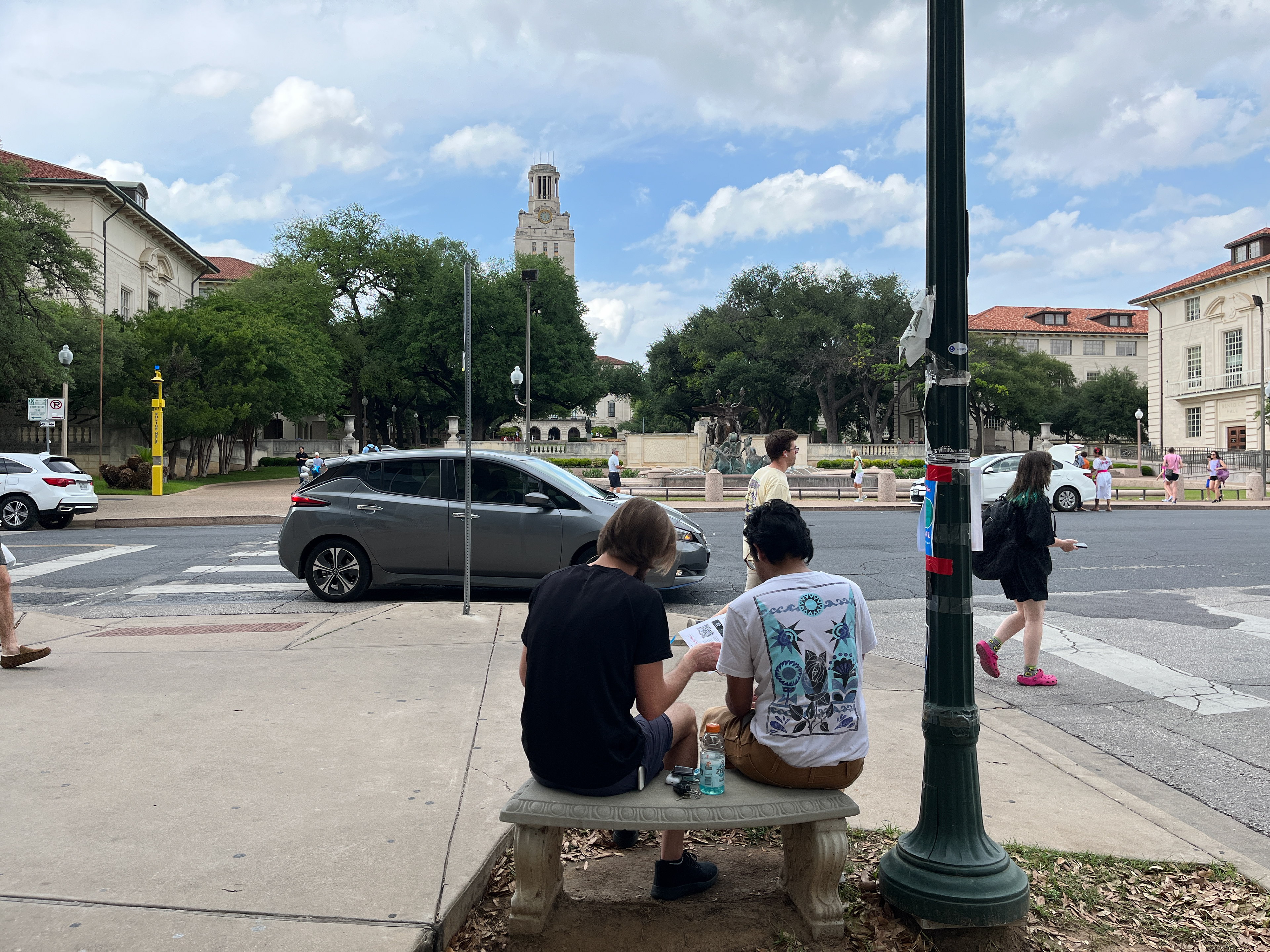 Ammar and Brandon figuring out the AR clue near Littlefield Fountain