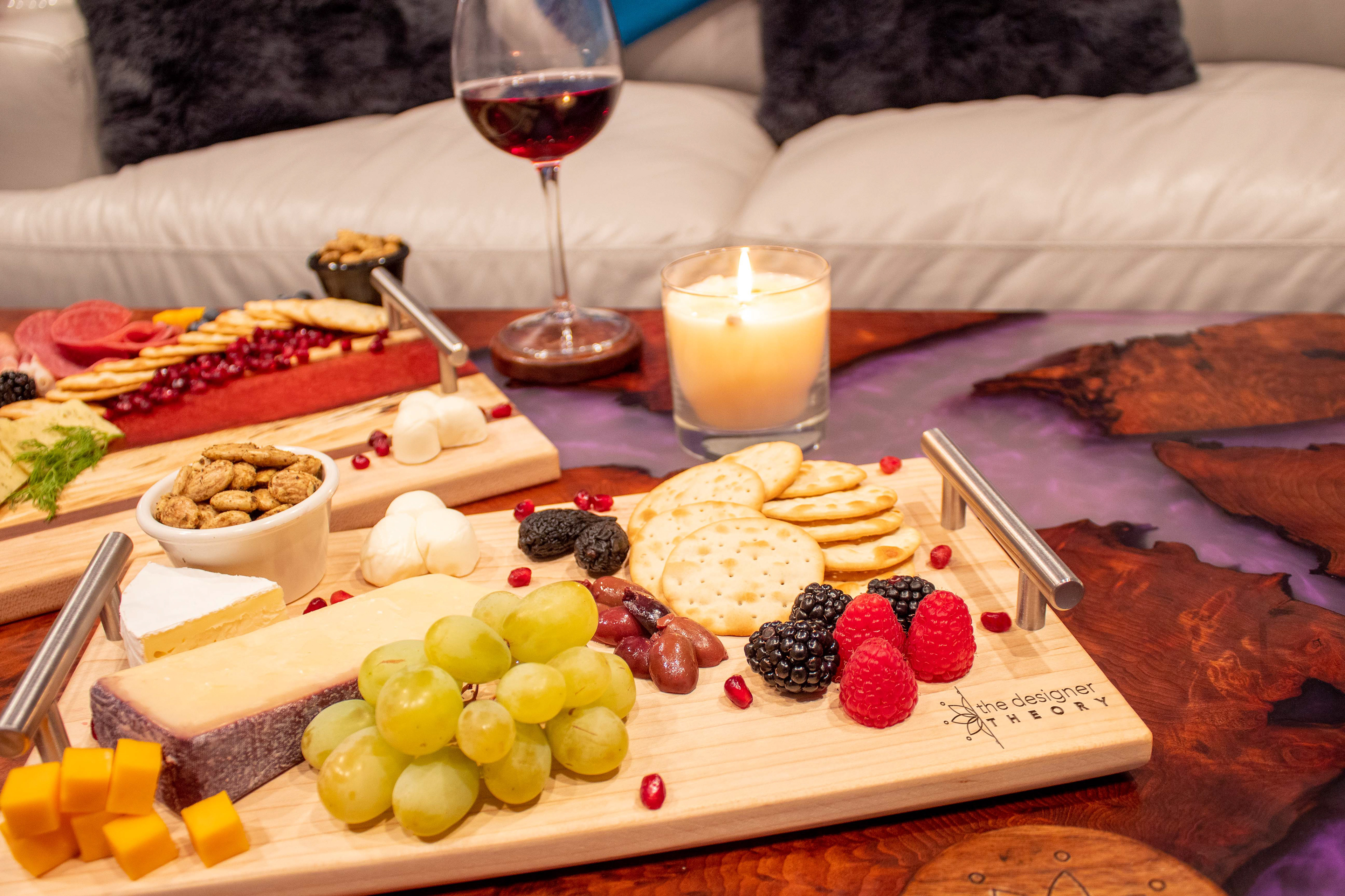 Laser Engraved and Resin River Charcuterie Boards, with coasters, on a Resin River Table