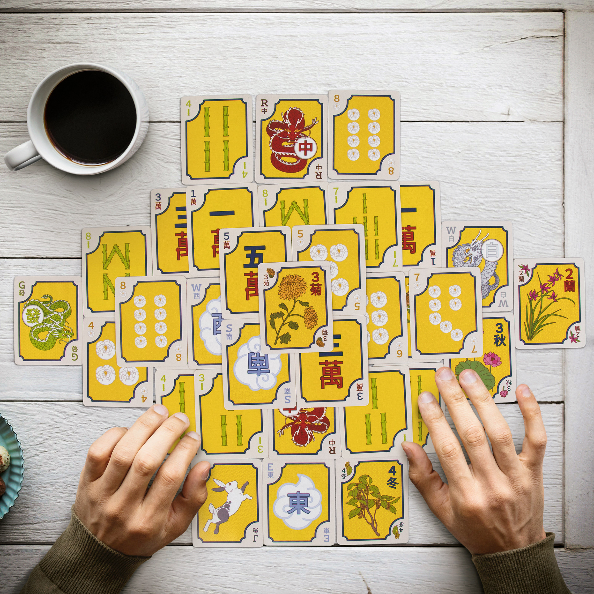 Composite of hands, tabletop scene, and cards.