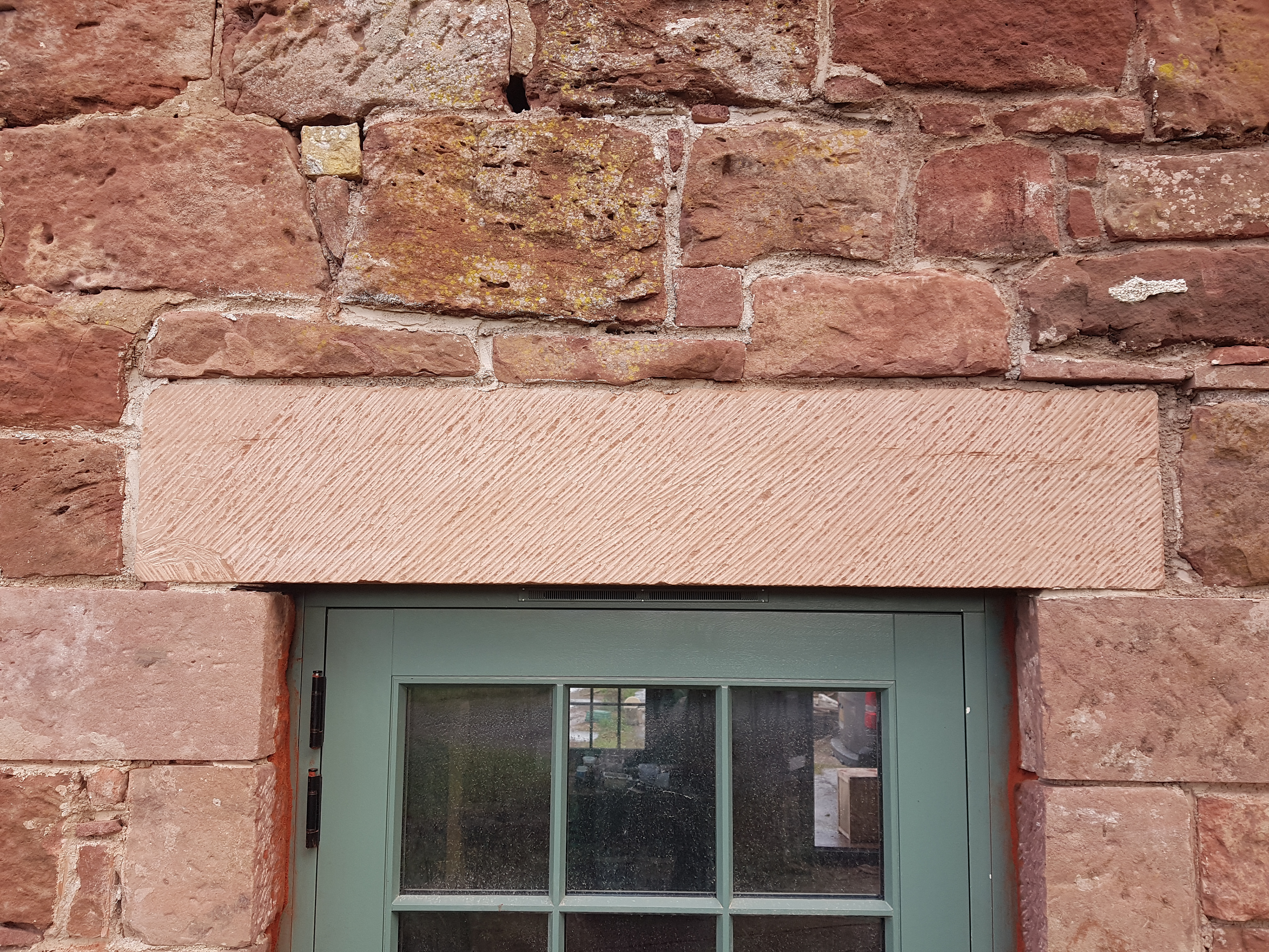 New stone lintel Castle Moffat Steading Long Barn historic listed building conversion restoration architecture by Croftworks in East Lothian Scotland retrofit stone farm buildings