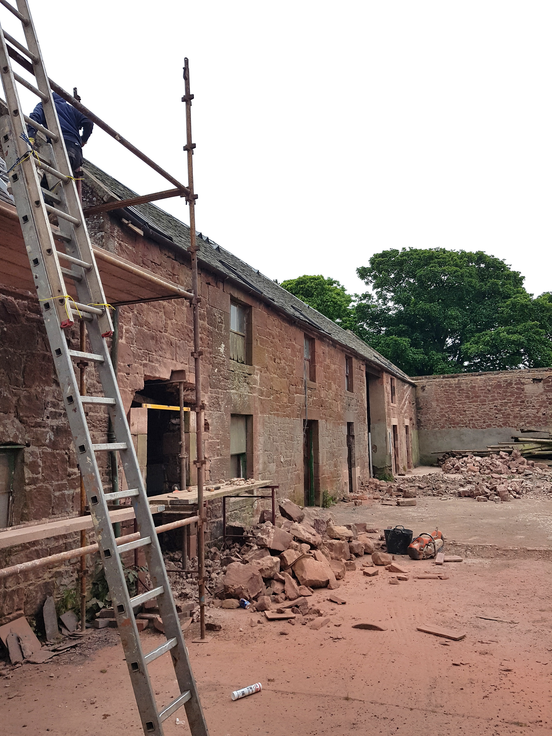 Making new stone openings Castle Moffat Steading Long Barn historic listed building conversion restoration architecture by Croftworks in East Lothian Scotland retrofit stone farm buildings