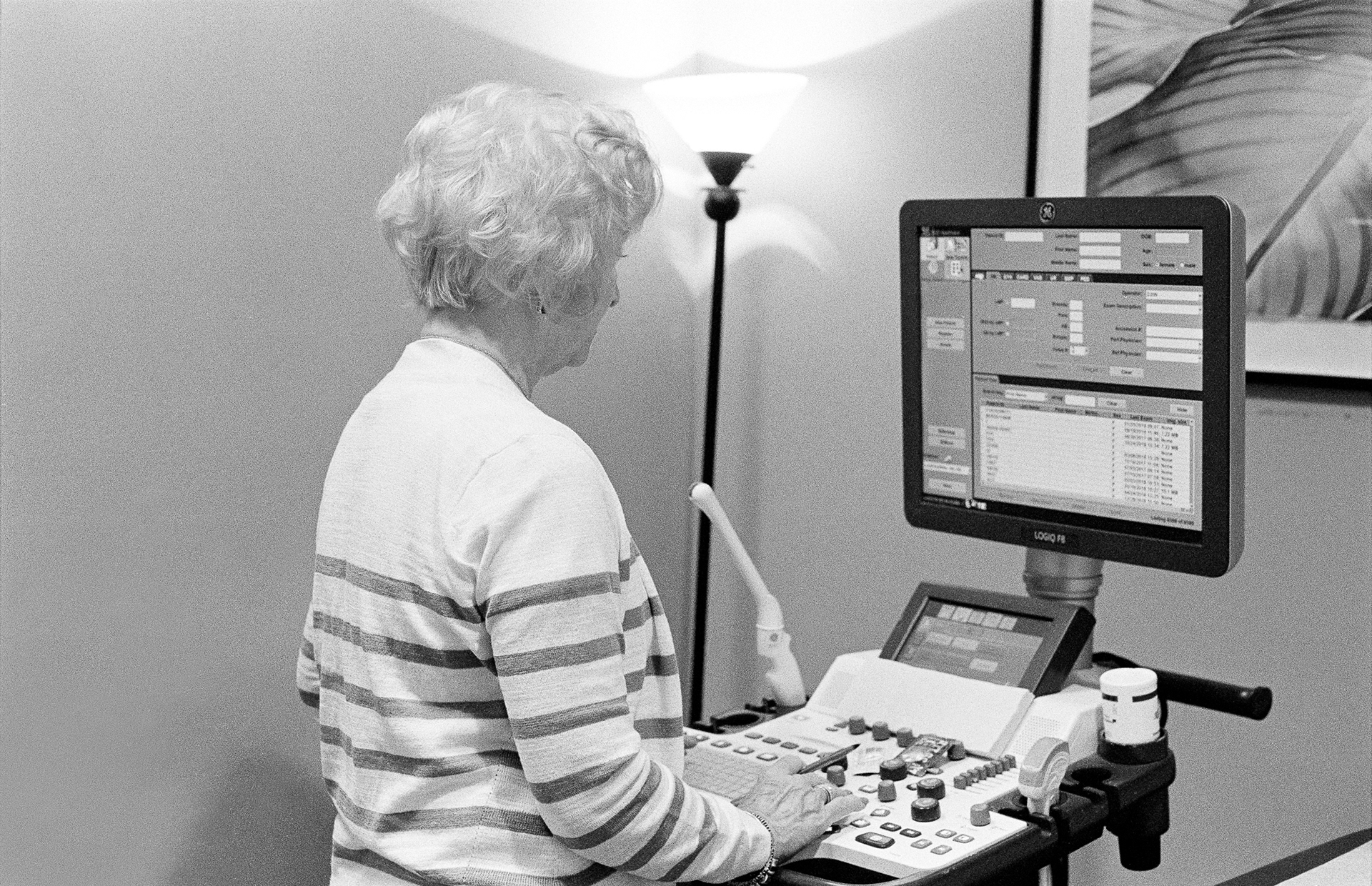 a woman working at an ultrasound machine