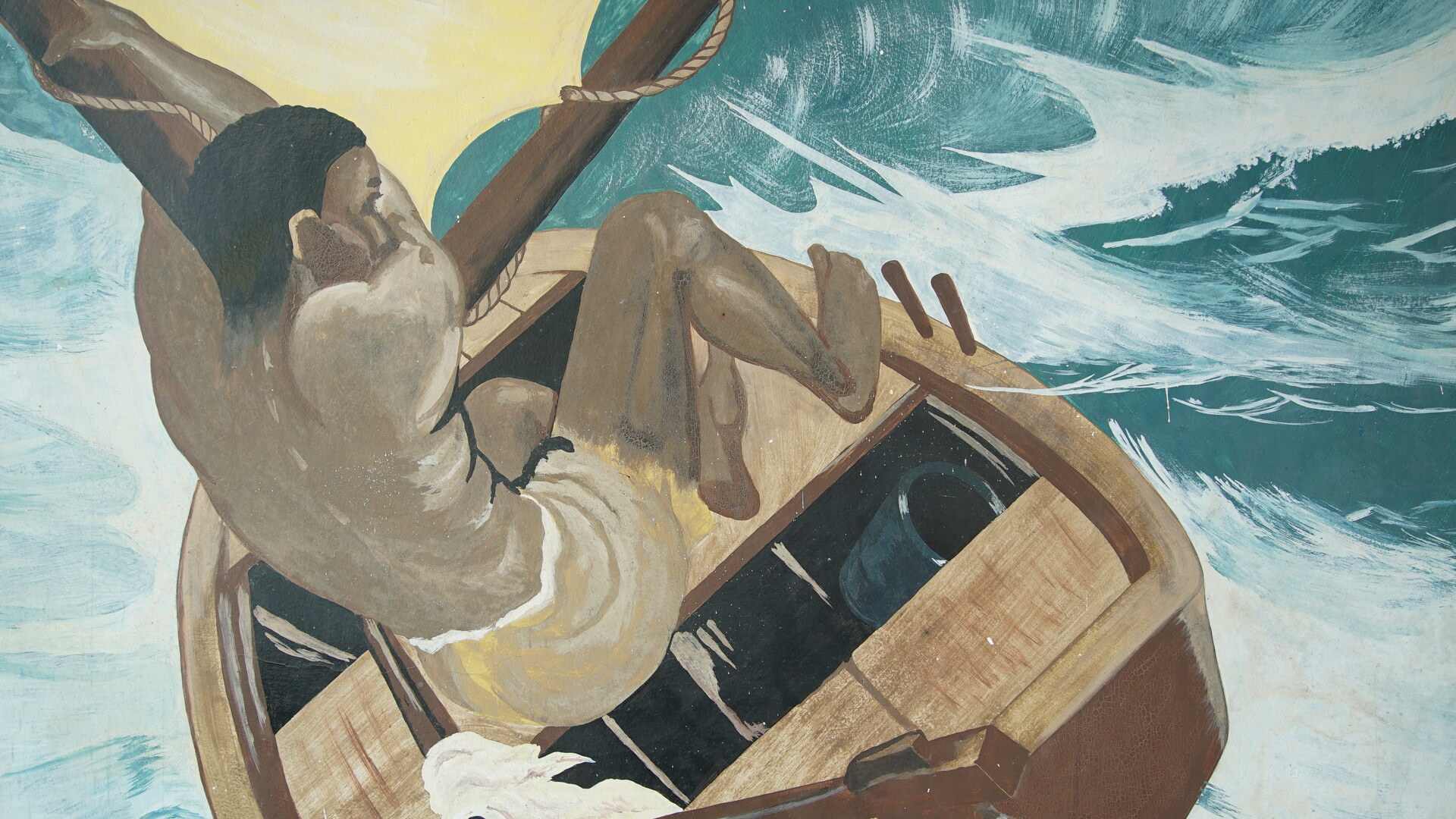 Foto do filme, uma pintura em cores desbotadas, de um homem negro de cabelo curto, sem camisa, velejando um barco com ondas do mar revoltosas no fundo