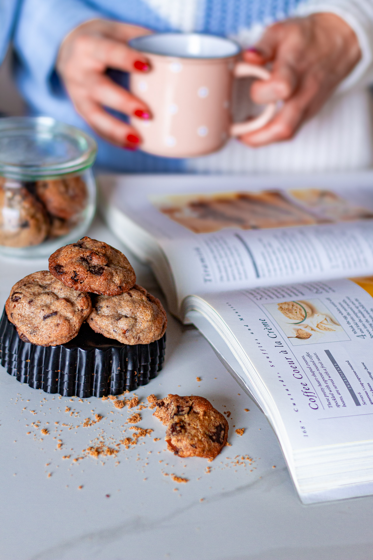 Woman with a book, cookies, cookie jar and coffee