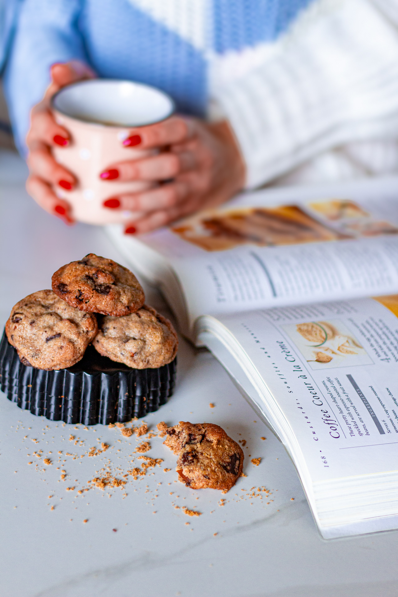 Woman with a book, cookies and coffee
