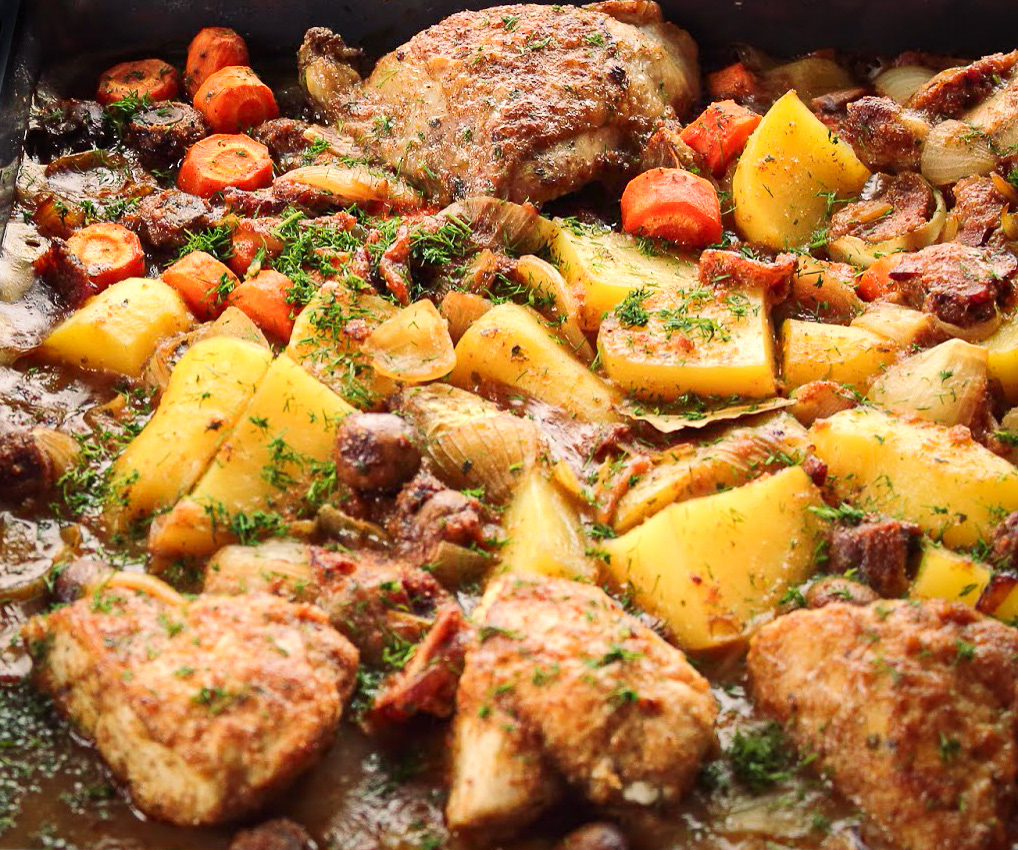 Roasted Chicken thighs along with potatoes, carrots, mushrooms and herbs and delicious brown glistening sauce
