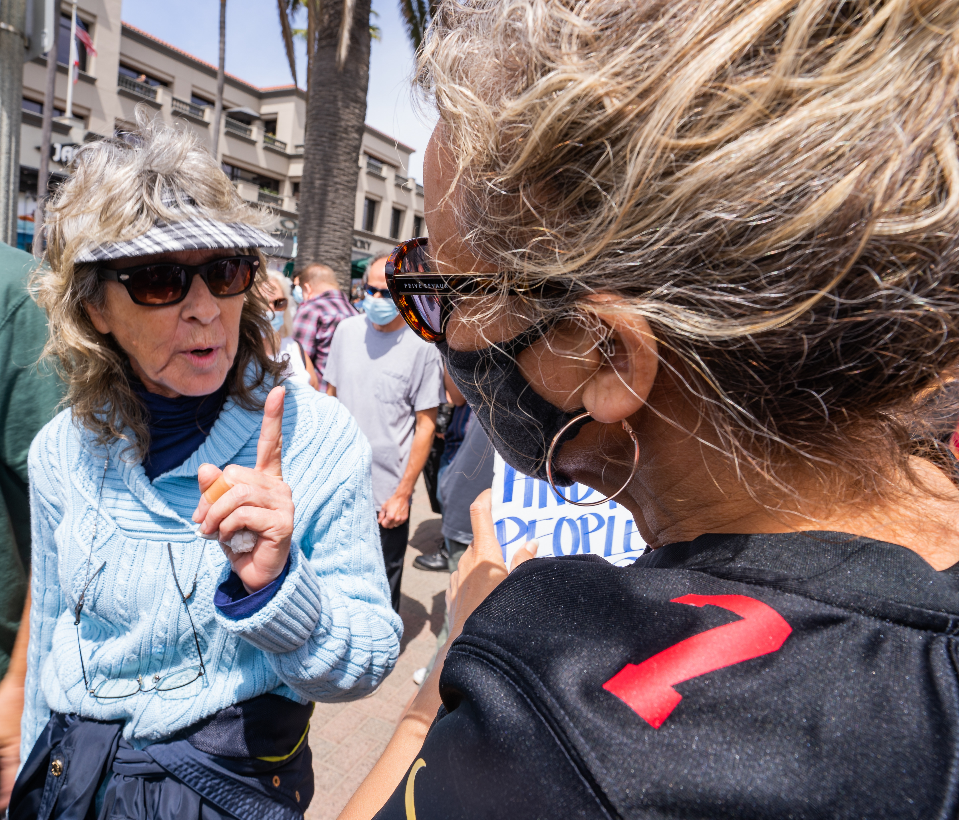 CONFRONTATION - Two women enter a heated debate about black on black crime. The woman in the light blue sweater, left, lectured the protester, right, on the merits of former secretary of housing and urban development, Ben Carson, as a role model for ‘good” African Americans. Sunday, April 11, 2021.