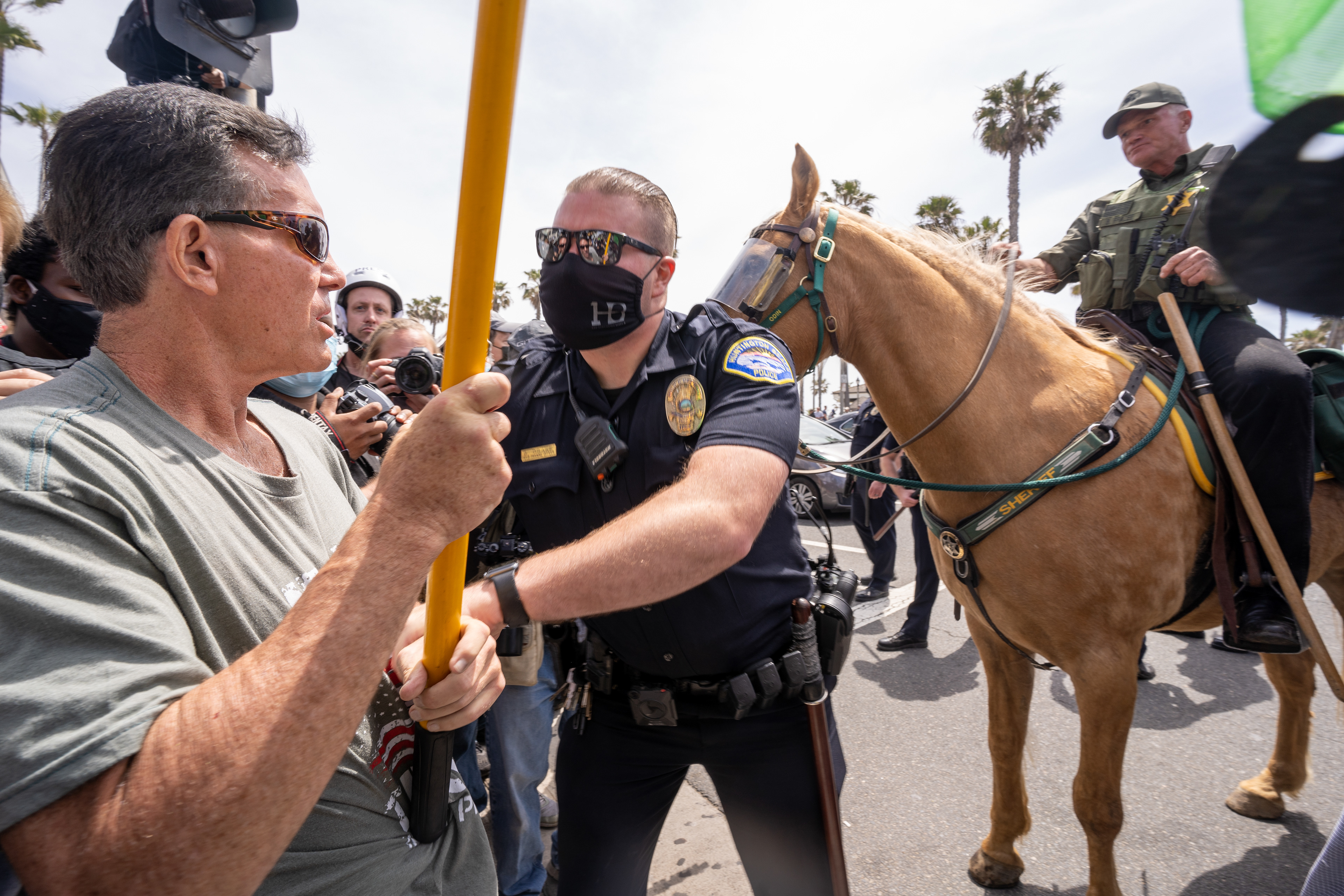 ARRESTED - One of the few White Lives Matter protesters to show, left, is arrested by the Huntington Beach Police Department. There were few protesters claiming a direct link to the White Lives March, but many individuals with racist propaganda engaged anti-supremacist protesters. Sunday, April 11, 2021.