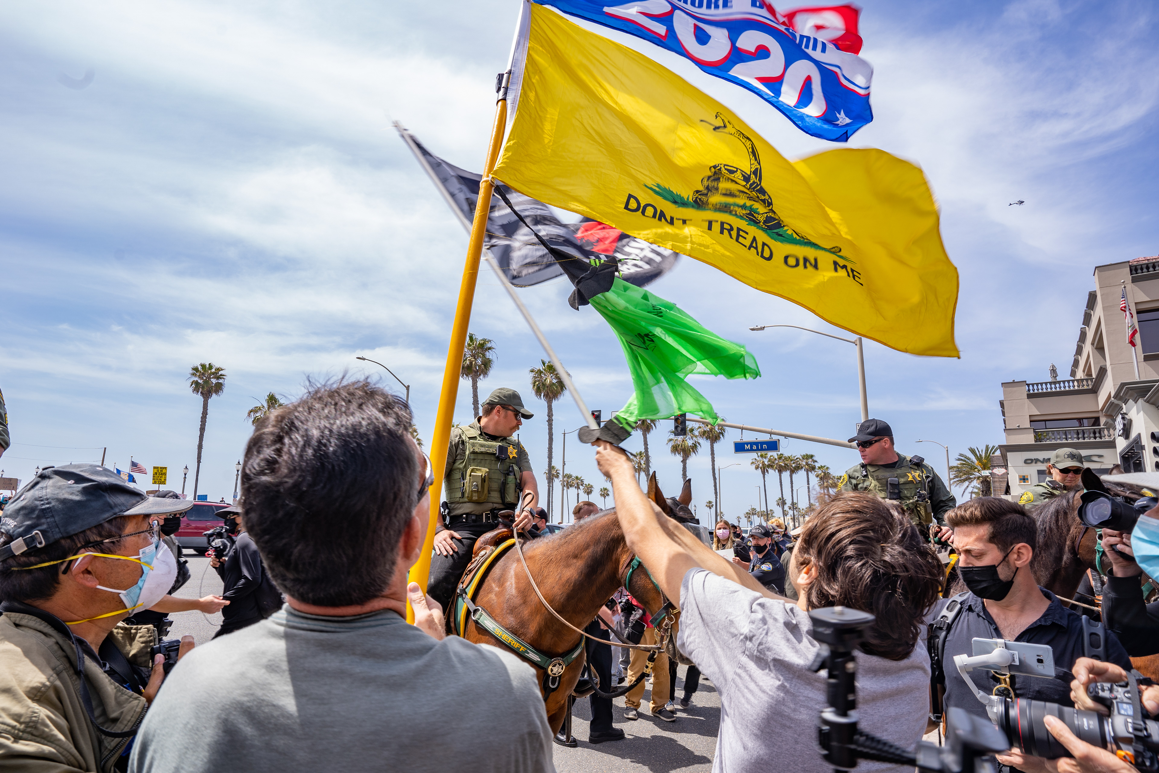 Two White Lives Matter supporters wave thier flags at antiracist protesters across the street. Mounted police were brought in to keep the two groups seperate. Sunday, April 11, 2021. (Photo by Solomon O. Smith/ The Valley Star)