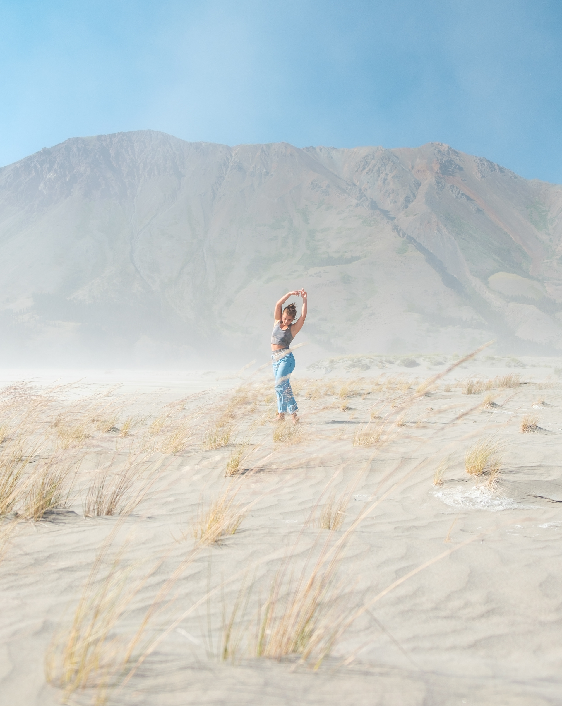 Rooted. Avery taking dance lessons from grass in the Kluane Lake bed. On the Traditional Territories of Kluane First Nation and the Champagne and Aishihik First Nations.