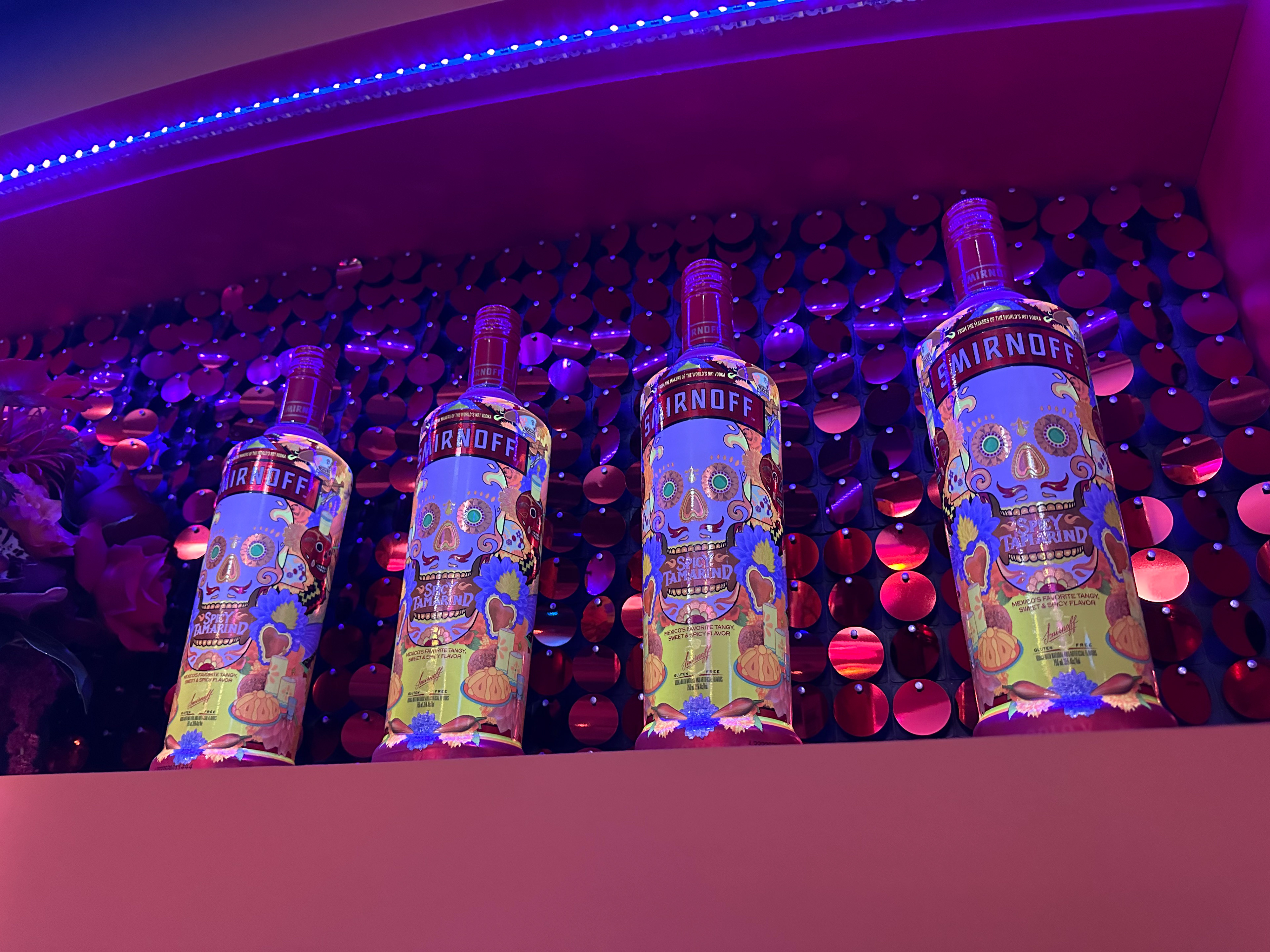 Glowing bottles under a changing blacklight