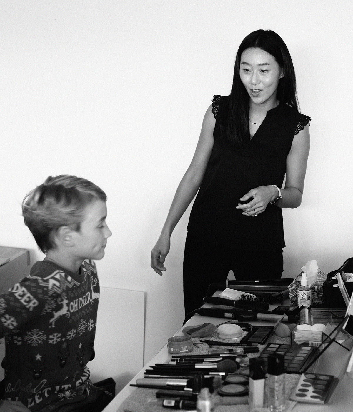 Great Black and white portrait in a make up station, Asian Make up artist working with one of the kids of the film production.Made by Emotion Graphics. This was a cast for a TV Xmans IDS. Video Production and film Animation Munich. Photography by Rob Adalierd - Aitor Benavent. A film for Disney channel in 2022