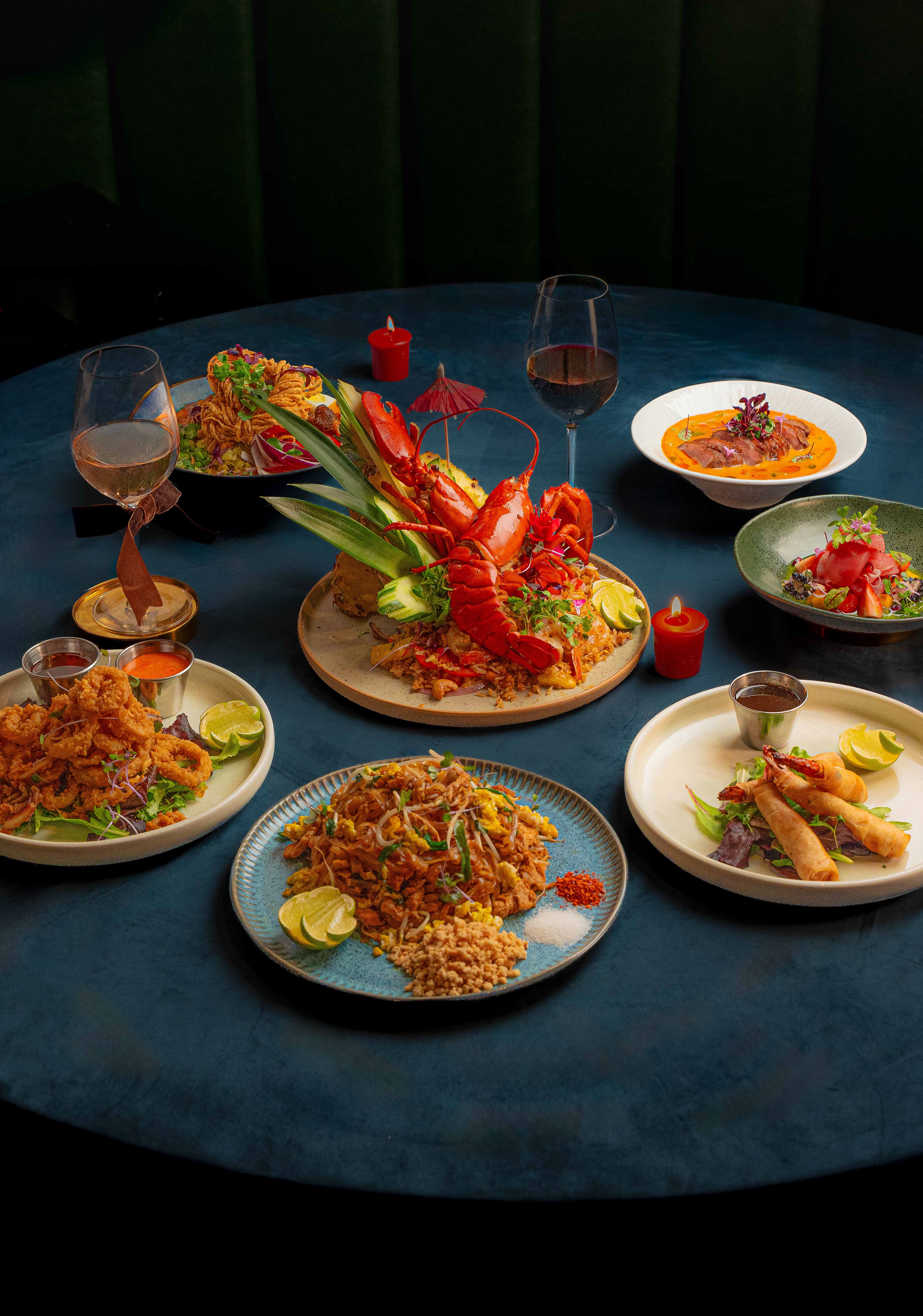 Expertly styled flat lay of a luxury multi-course dinner featuring lobster, spring rolls, and noodles, showcasing creative food styling for high-end restaurant social media and Instagram marketing in Toronto.