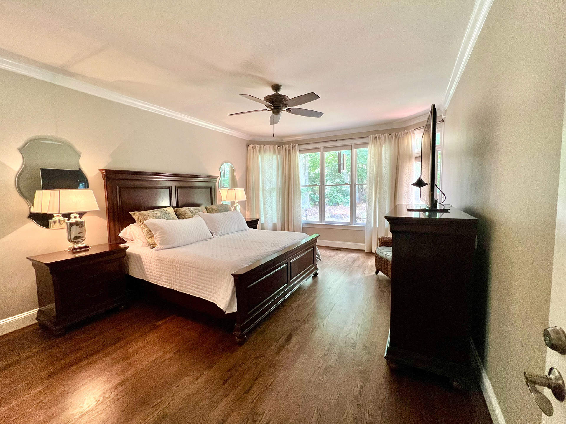 Large primary bedroom with expansive windows
