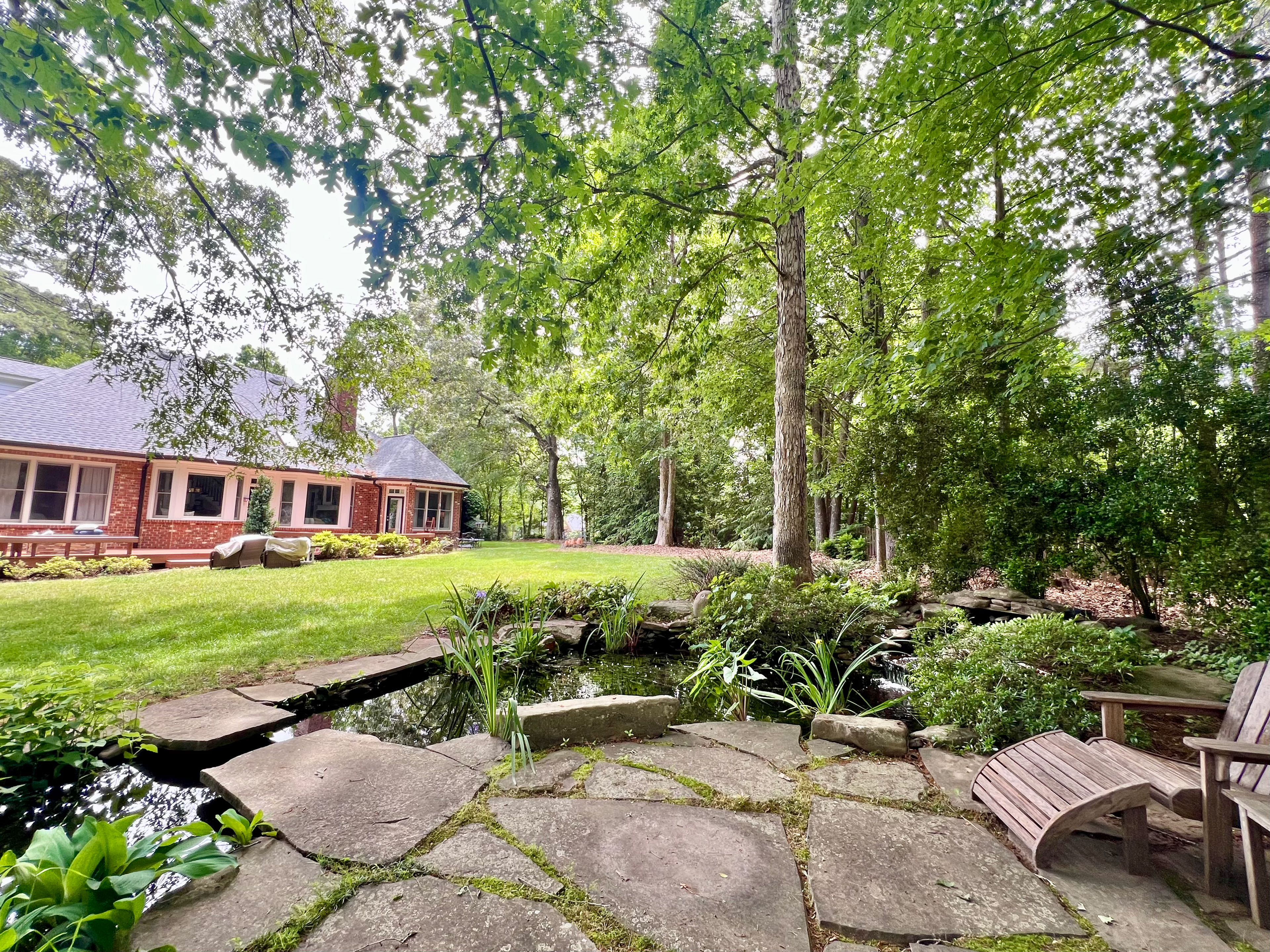 Flagstone terrace and Adirondacks by pond