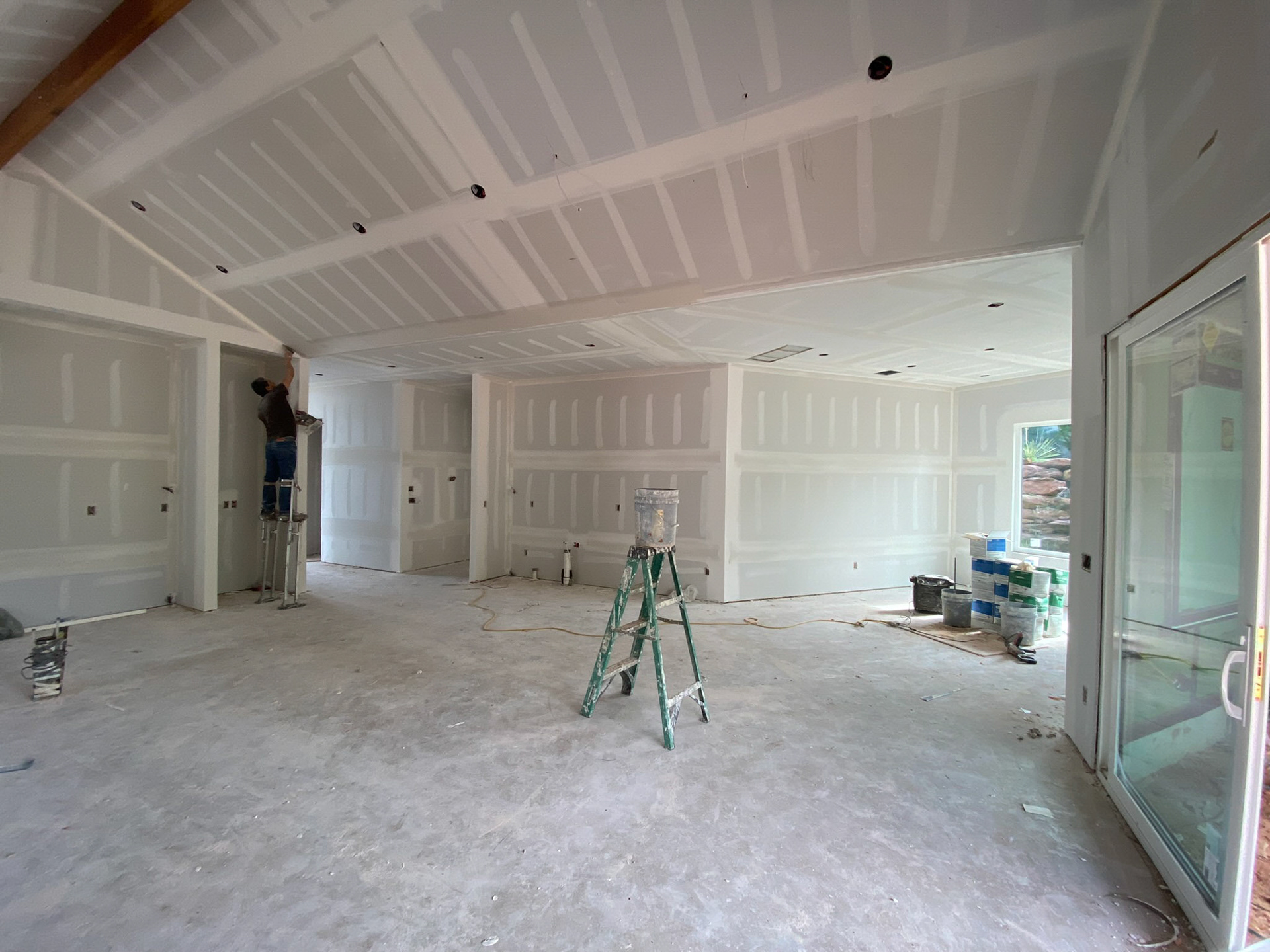 View from the Living and kitchen areas. Sheetrock installation and preparations for the paint wor
