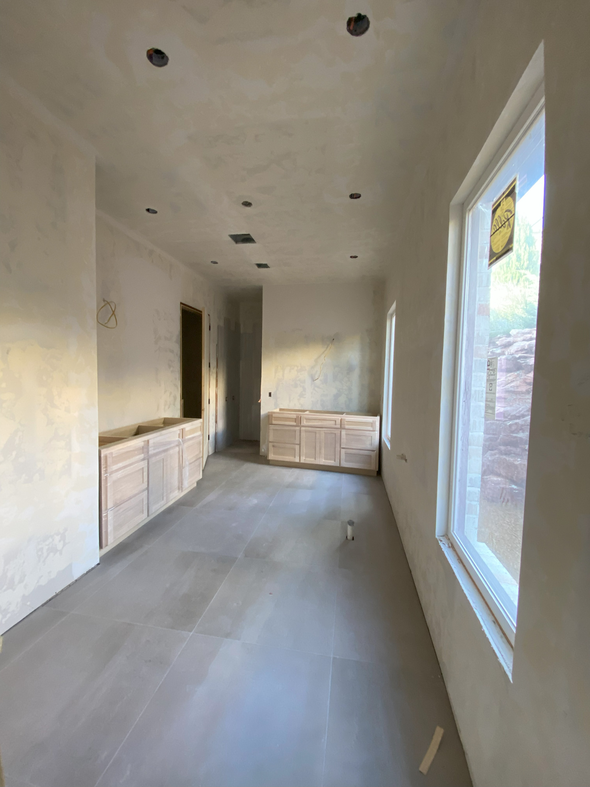 Prime bathrom with cabinets and tile floor installed
