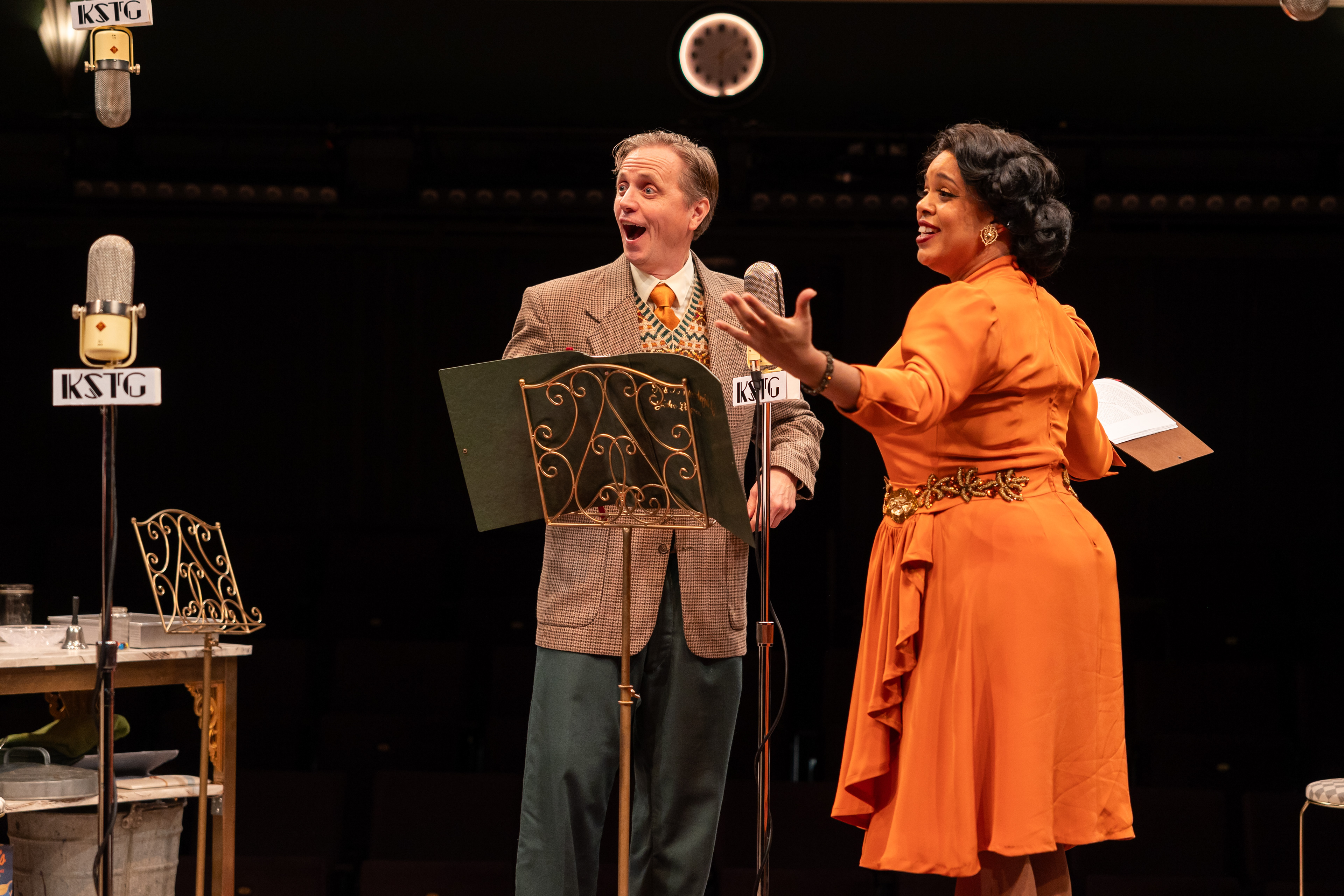 It’s A Wonderful Life: A Live Radio Play   stageshouston.com  WRITTEN BY: JOE LANDRY DIRECTED BY: DEREK CHARLES LIVINGSTON BASED ON THE STORY "THE GREATEST GIFT" BY PHILIP VAN DOREN STERN PRODUCERS: AMY SUTTON AND GARY CHILES  Photo courtesy of Stages Pictured: Cast of It's a Wonderful Life: A Live Radio Play, Stages (2025). Photo by: Melissa Taylor  CREATIVE TEAM Stage Manger: Carlos Cantu Scenic & Properties Designer: Jodi Bobrovsky Lighting Designer: Bryan Ealey Costume Designer: Leah Smith Sound Designer: Robert Leslie Meek Wig Stylist: Gisell Rubio  CAST VIOLET, et al: DeShae LaShawn Mary, et al: Jillian Linton Potter, et al: Gabriel Regojo George Bailey: Ryan Schabach Joseph, et al: Christopher Szeto-Joe  Clarence, et al: Pamela Vogel