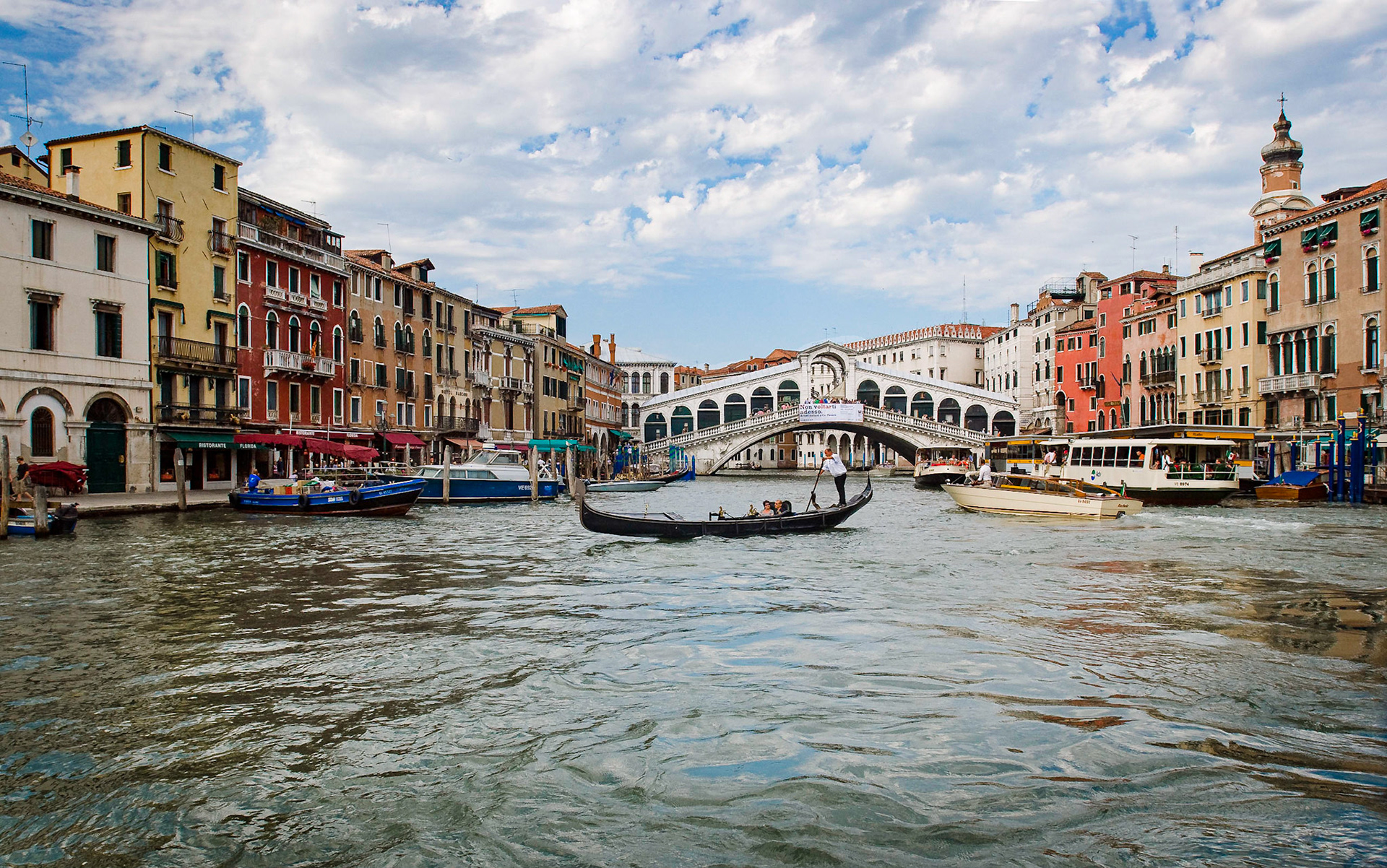 There is nothing more quintessentially Venetian than a gondoliero poling his craft across the Grand Canal just below the Ponte Rialto, the Royal Bridge.  June 2009