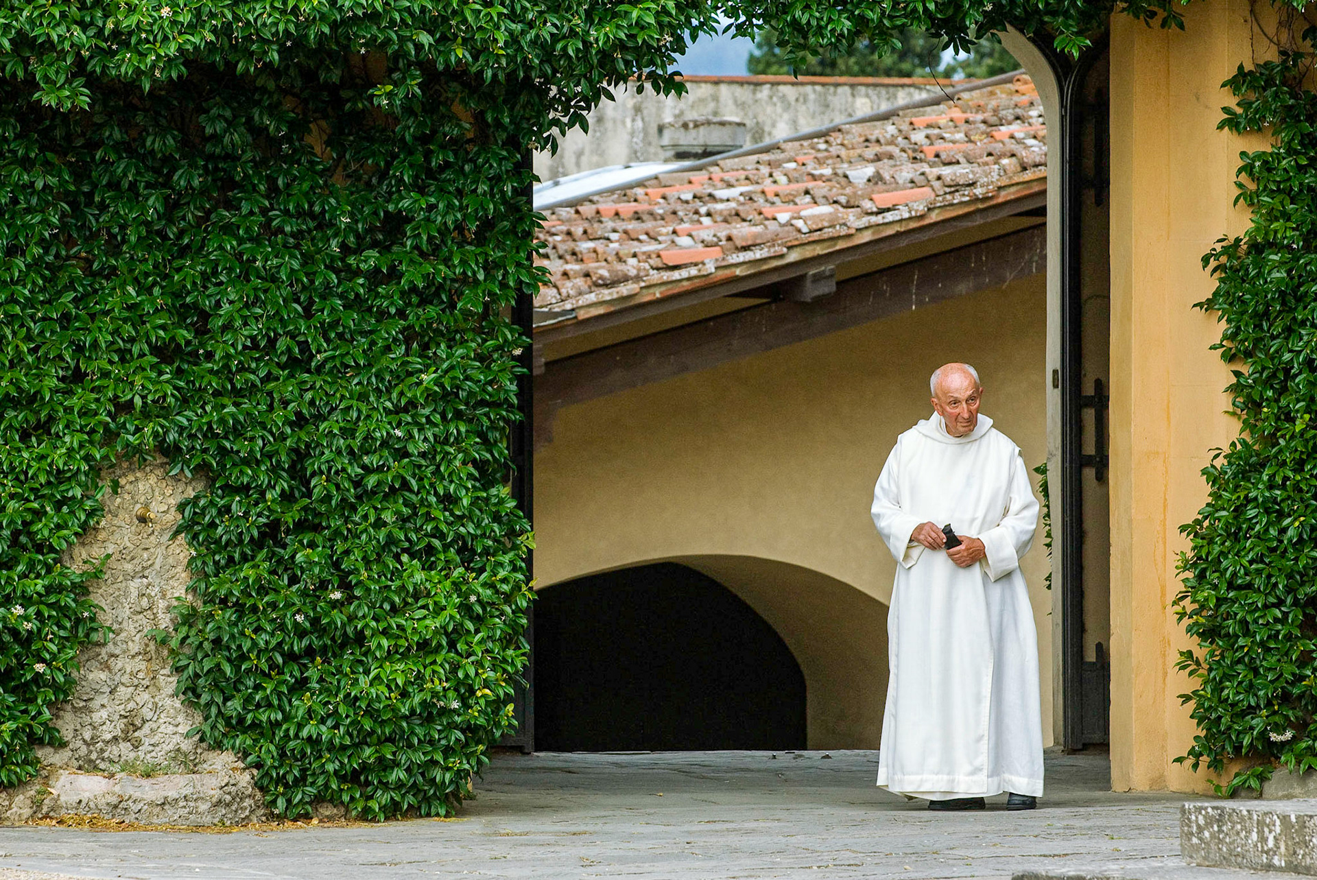 This white-robed cleric appeared in the courtyard leading from the Olivetan cloister at San Miniato al Monte.  June 2009