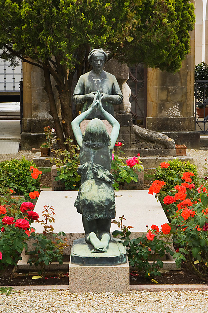Two bronzes grace a tomb in the cemetary at San Miniato al Monte, in Florence, Italy