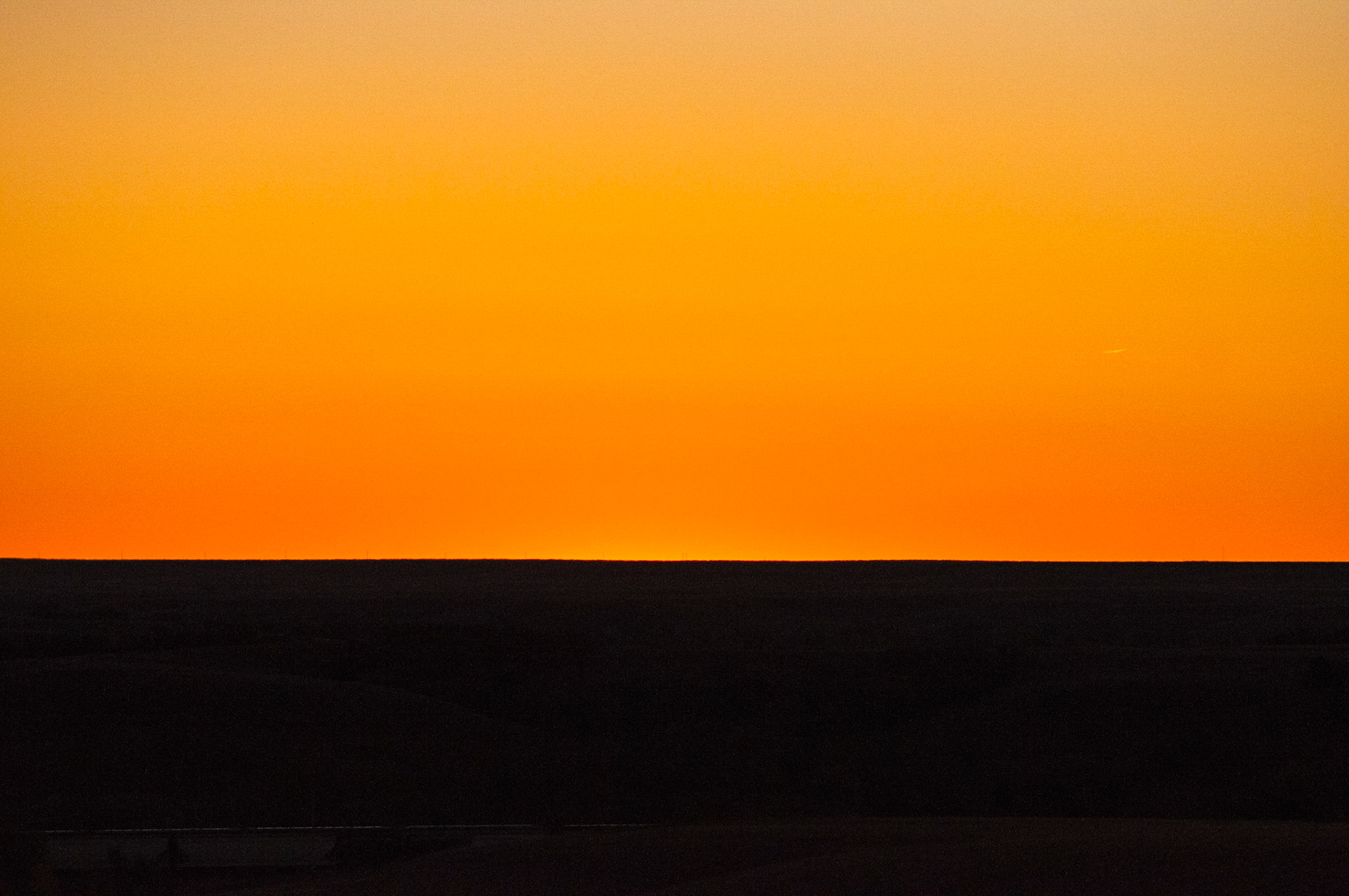 Exposing for the brilliance of the evening sky in the Flint Hills underexposes the foreground to black, yielding a bi-tonal abstract scene.