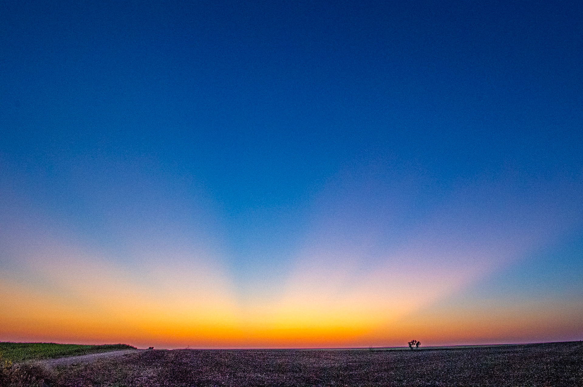 Crepuscular rays light the sky in the Flint Hills southwest of Pratt, Kansas.