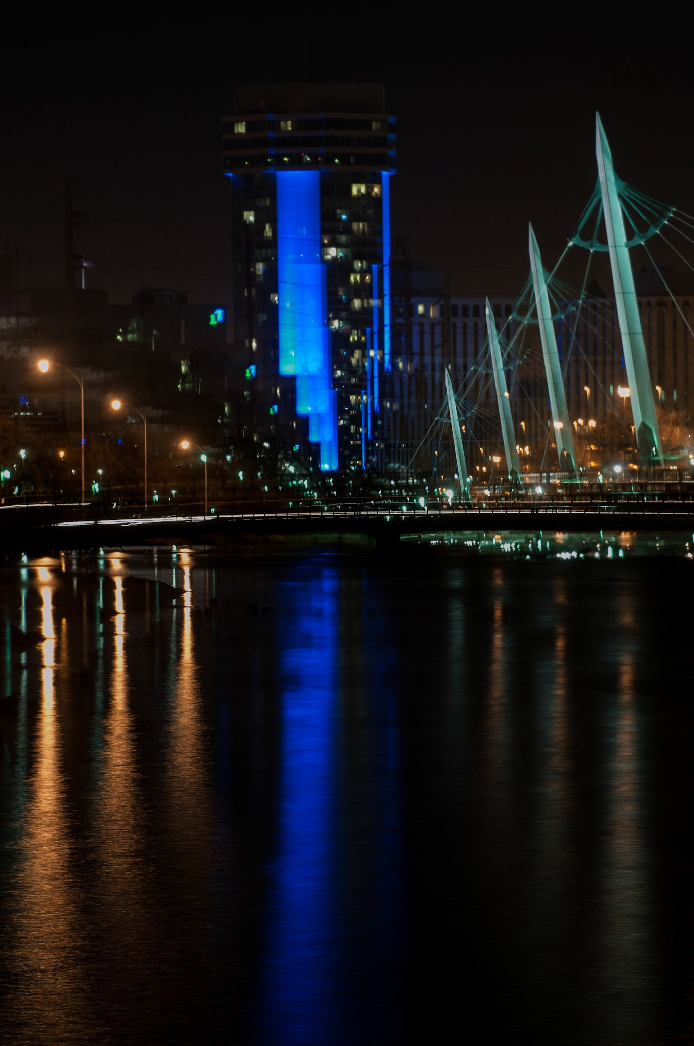 At some points along the Arkansas River flowing through downtown Wichita. Here, I’ve heightened the effect with a four-shot multiple exposure, the lens zoomed out a bit between each exposure. February, 2010