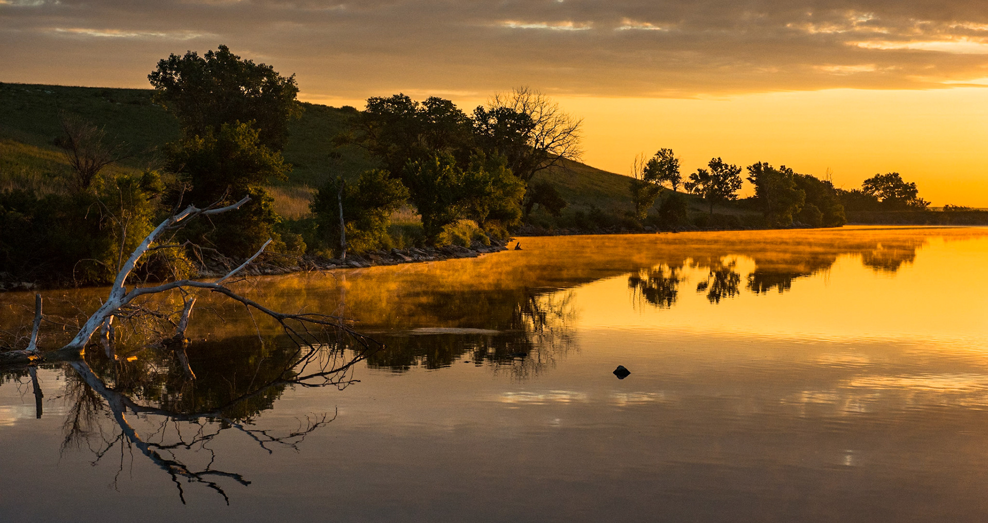 Morning mist hangs over the banks of the Chase County Fishing Lake near Cottonwood Falls.