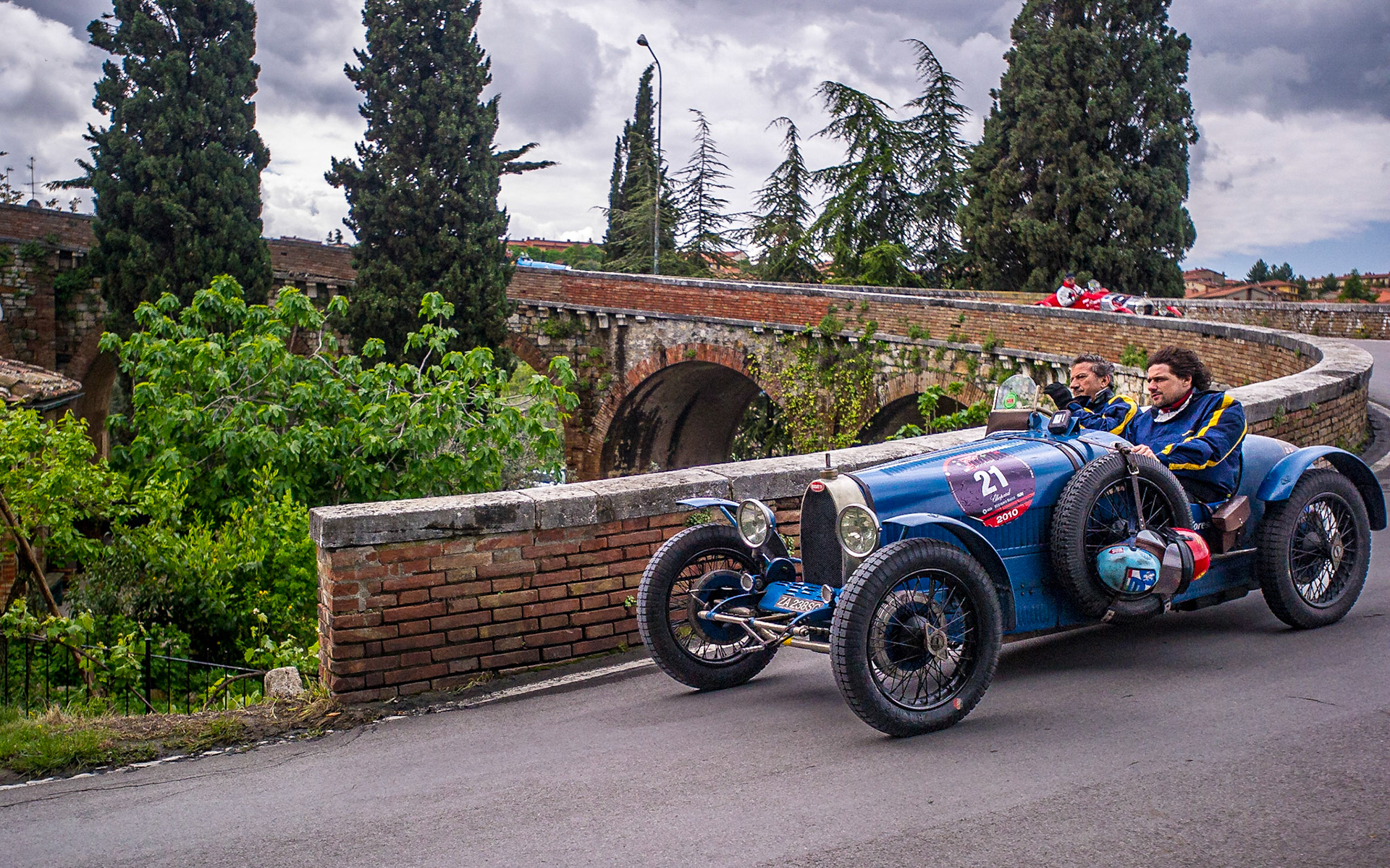 The contemporary Mille Miglia is a road rally for vintage cars. In 2010, I was in San Quirico d’Orcia when the parade of cars passed through. The vehicle captured here is a 1927 Bugatti Type 37.