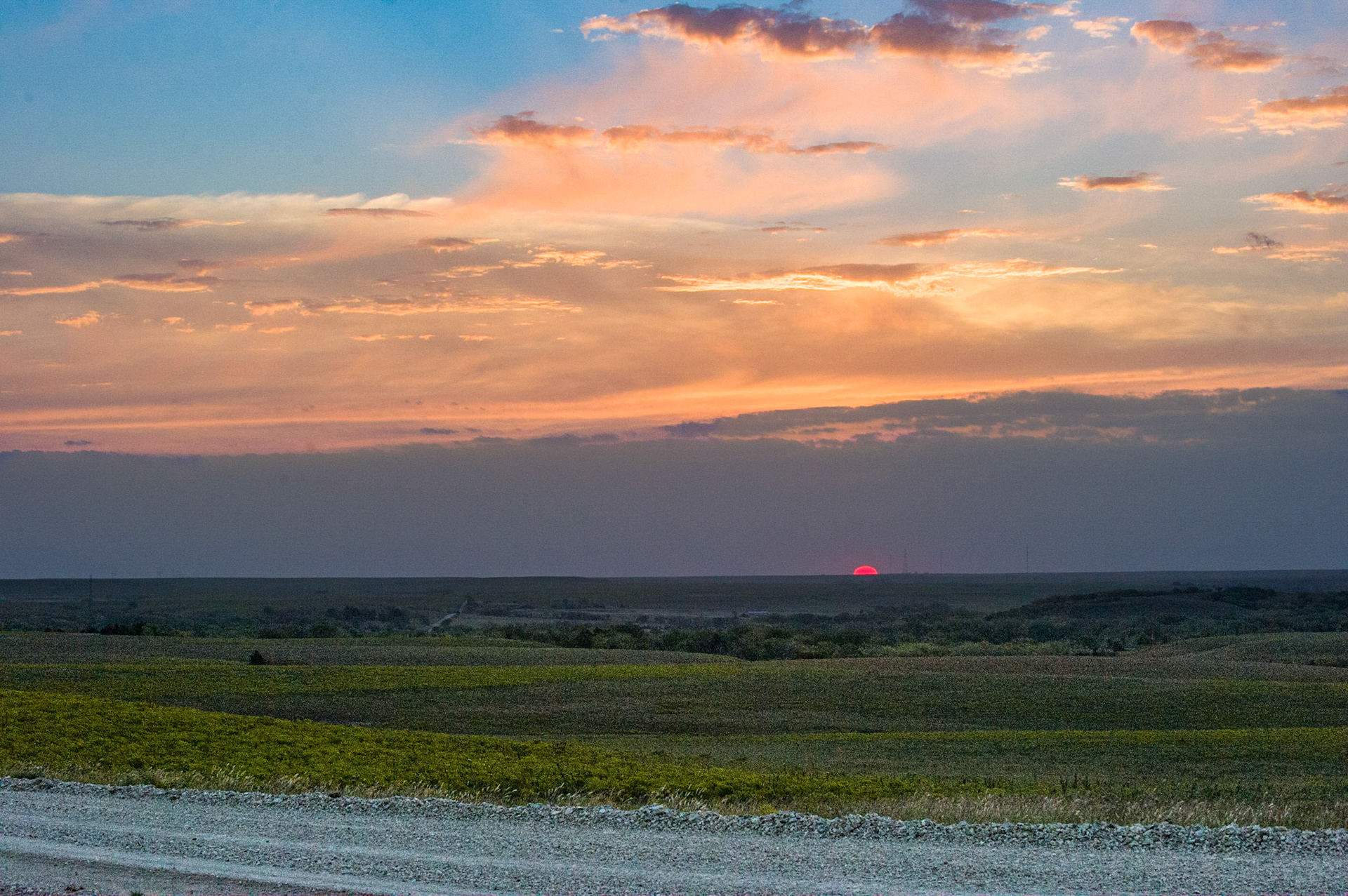 The last rim of the sun sets brilliantly over the Flint Hills.