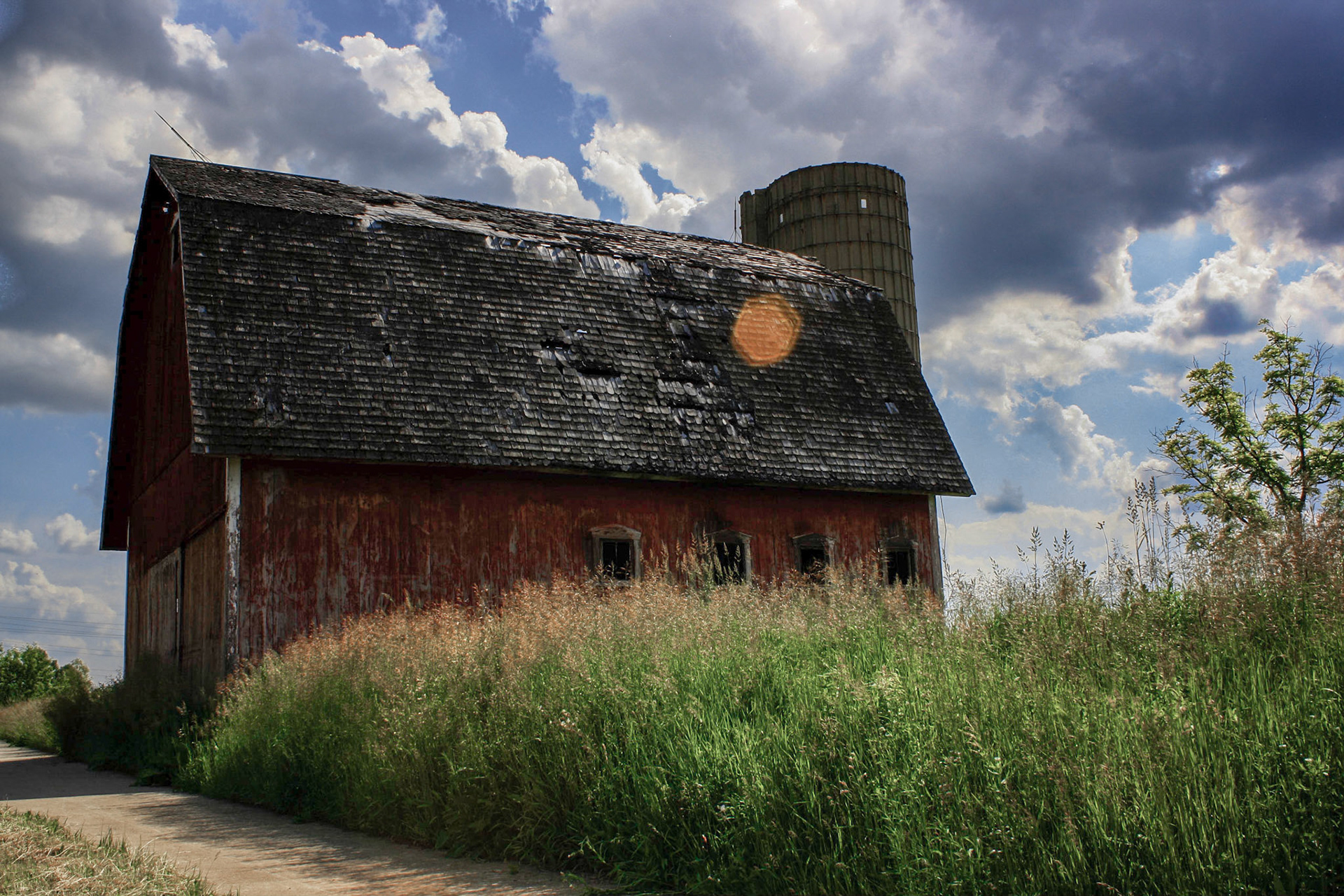 An old (looking) barn out near Okemos, MI. I know the barn itself came out a bit dark, but overall I still like the image. I did manage to find the original layered file and was able to bring a little brightness back to the image. It's not much though.