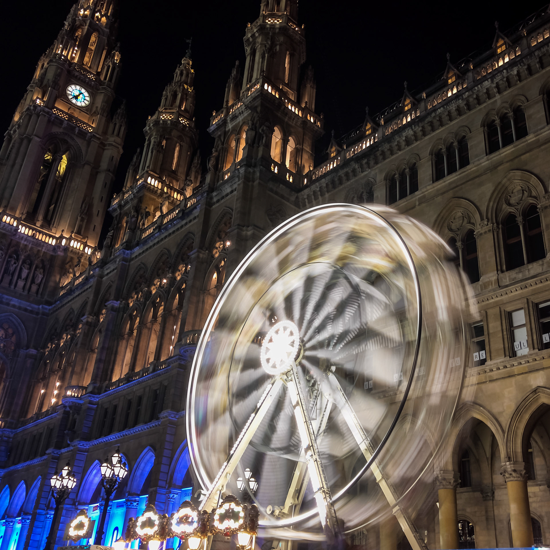 After the Christmas Season the square in front of the city hall is transformed into a huge ice skating rink with some additional attractions like this small ferris wheel. Photo taken with Slow Shutter Cam on iPhone 7 plus
