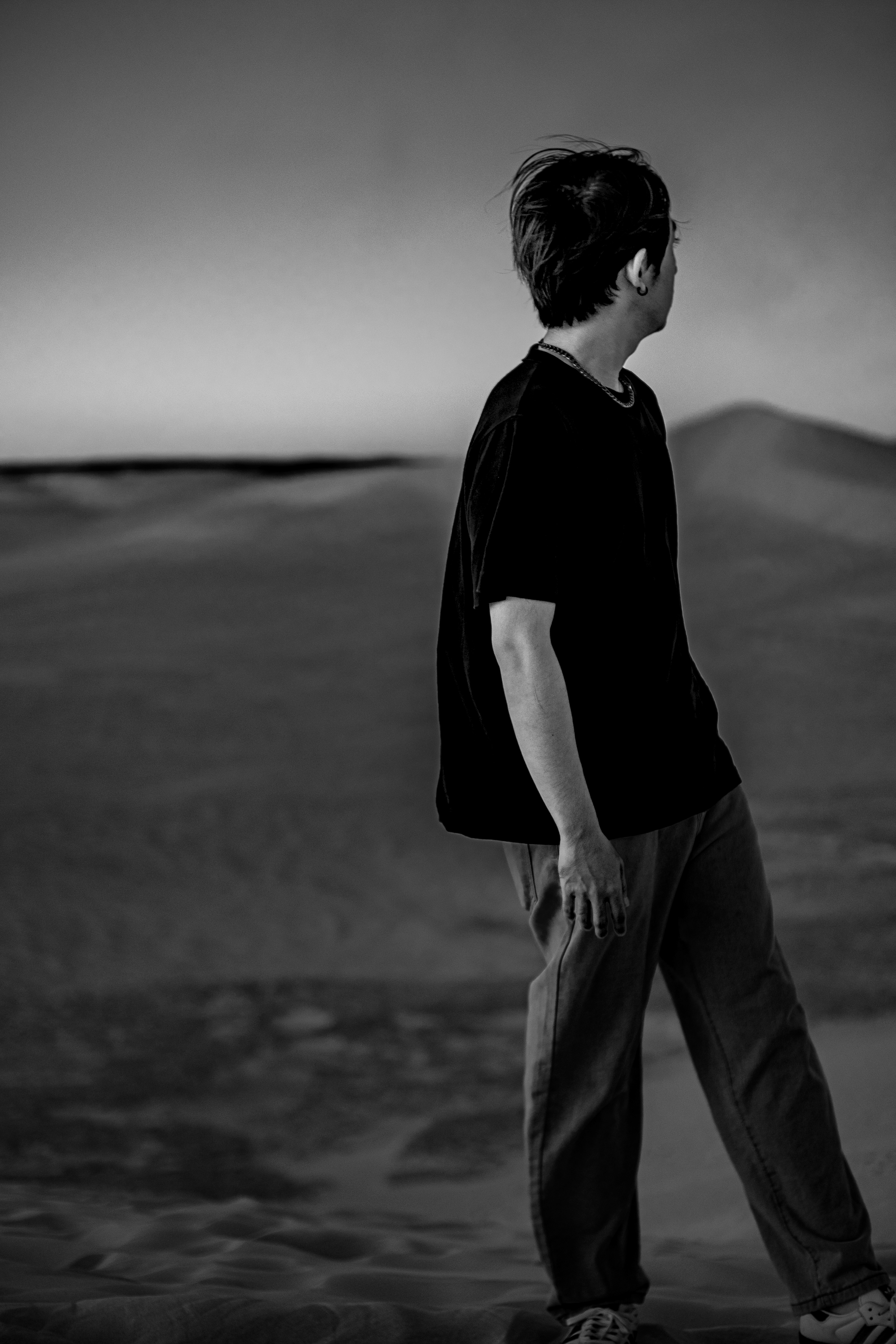 Back view of a man walking in Lancelin dunes, black and white portrait photography in Western Australia by FocusbyArmand