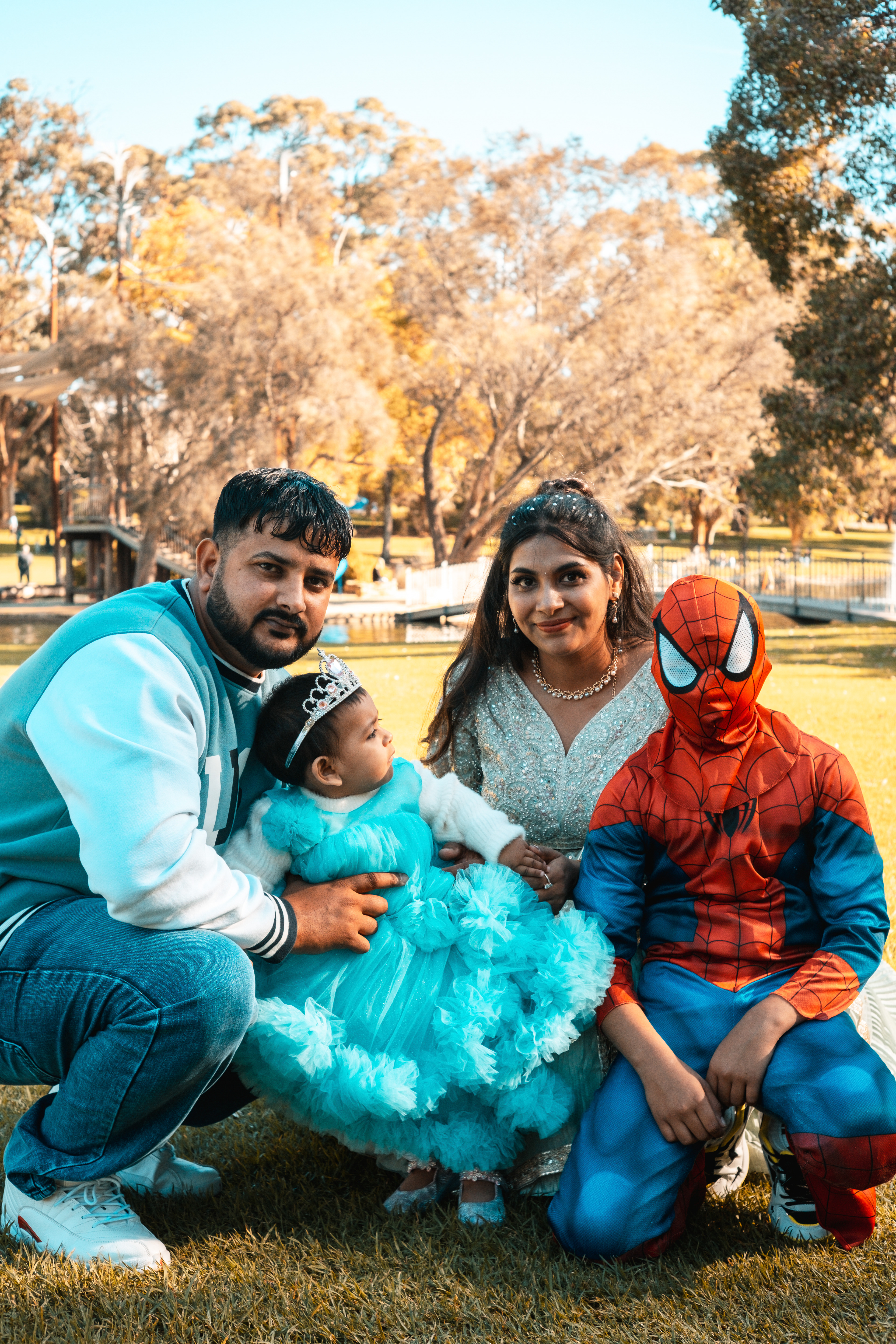 Parents holding their daughter in a vibrant blue birthday dress – Kings Park, Perth.