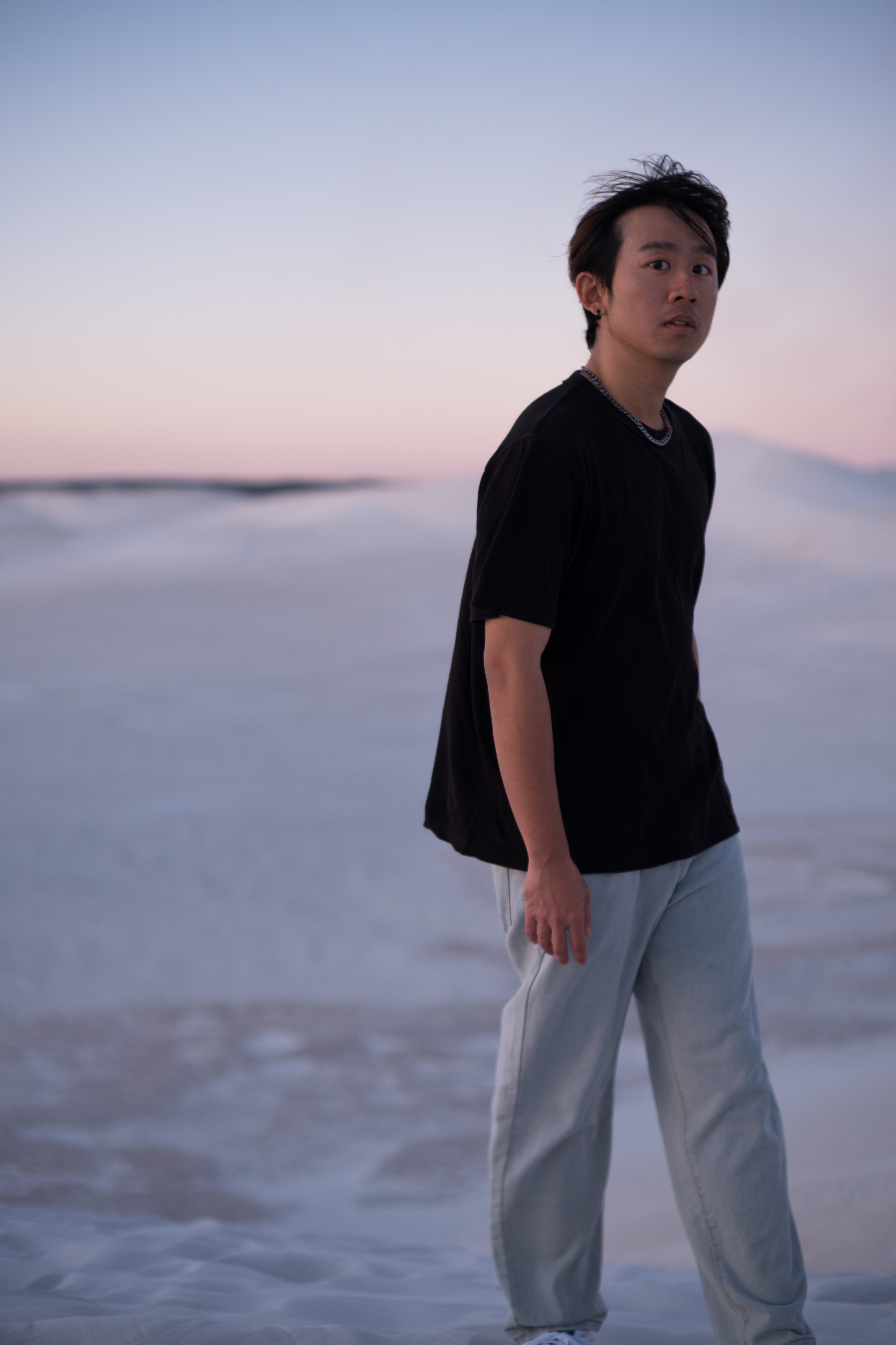 Portrait of a young man in natural light at the Lancelin sand dunes, taken during golden hour by FocusbyArmand.