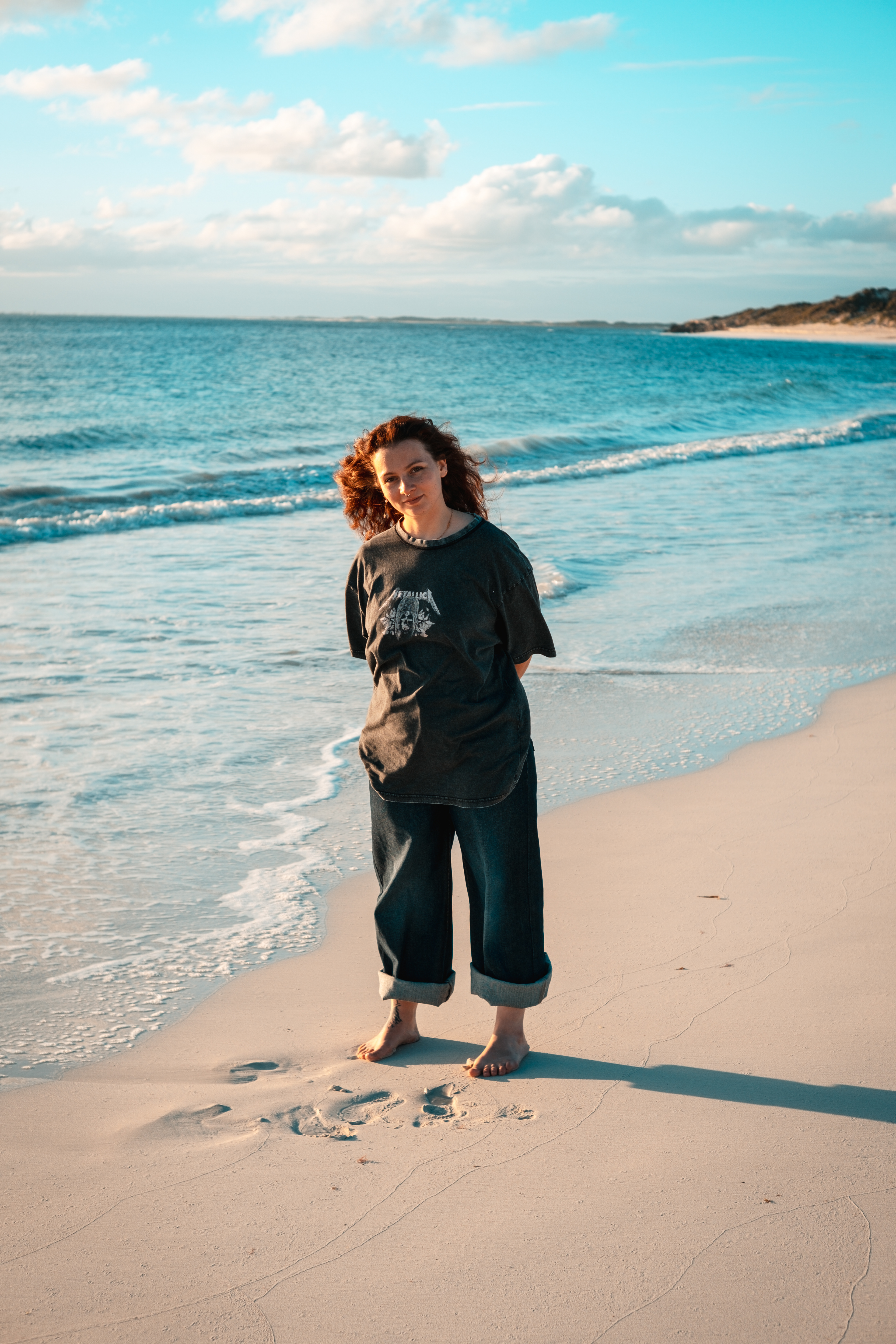 Cinematic over-the-shoulder look on Lancelin beach, footprints in sand, Focus by Armand