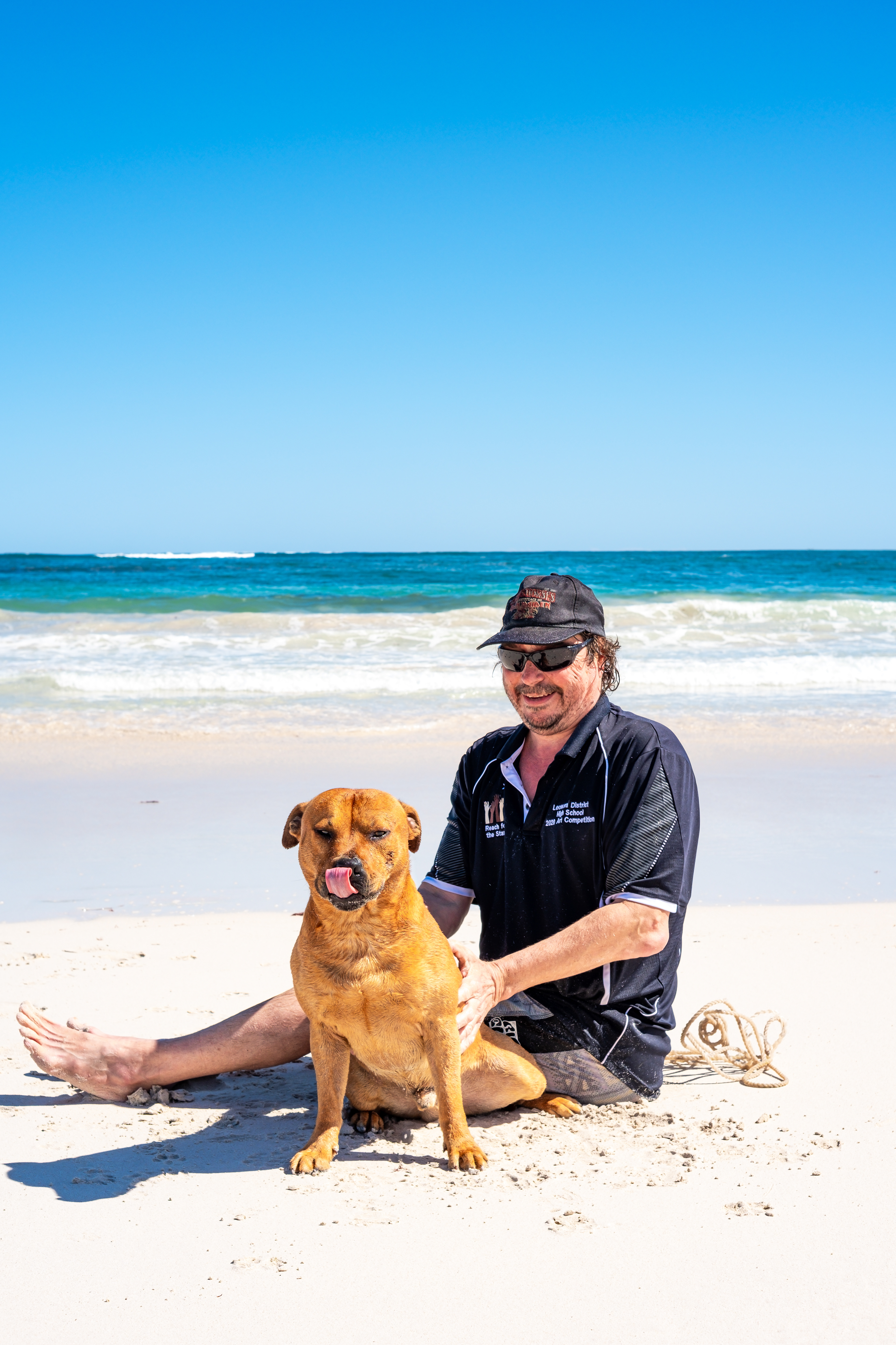 Capturing connection and trust – candid pet and owner moment at Lancelin Beach.