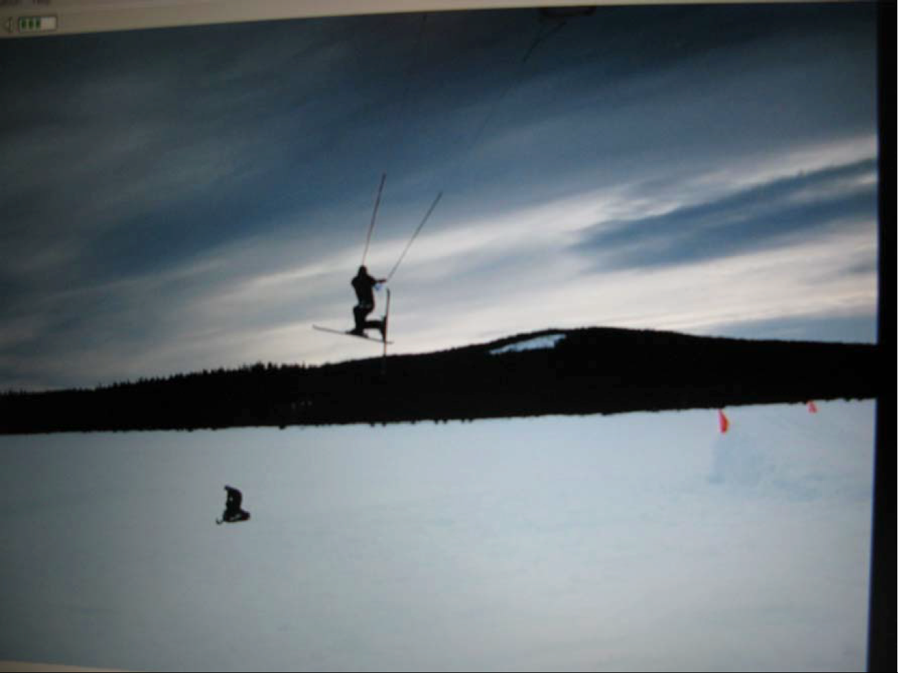 Kedzie Gunderson pulling some kind of stunt over the frozen lake.