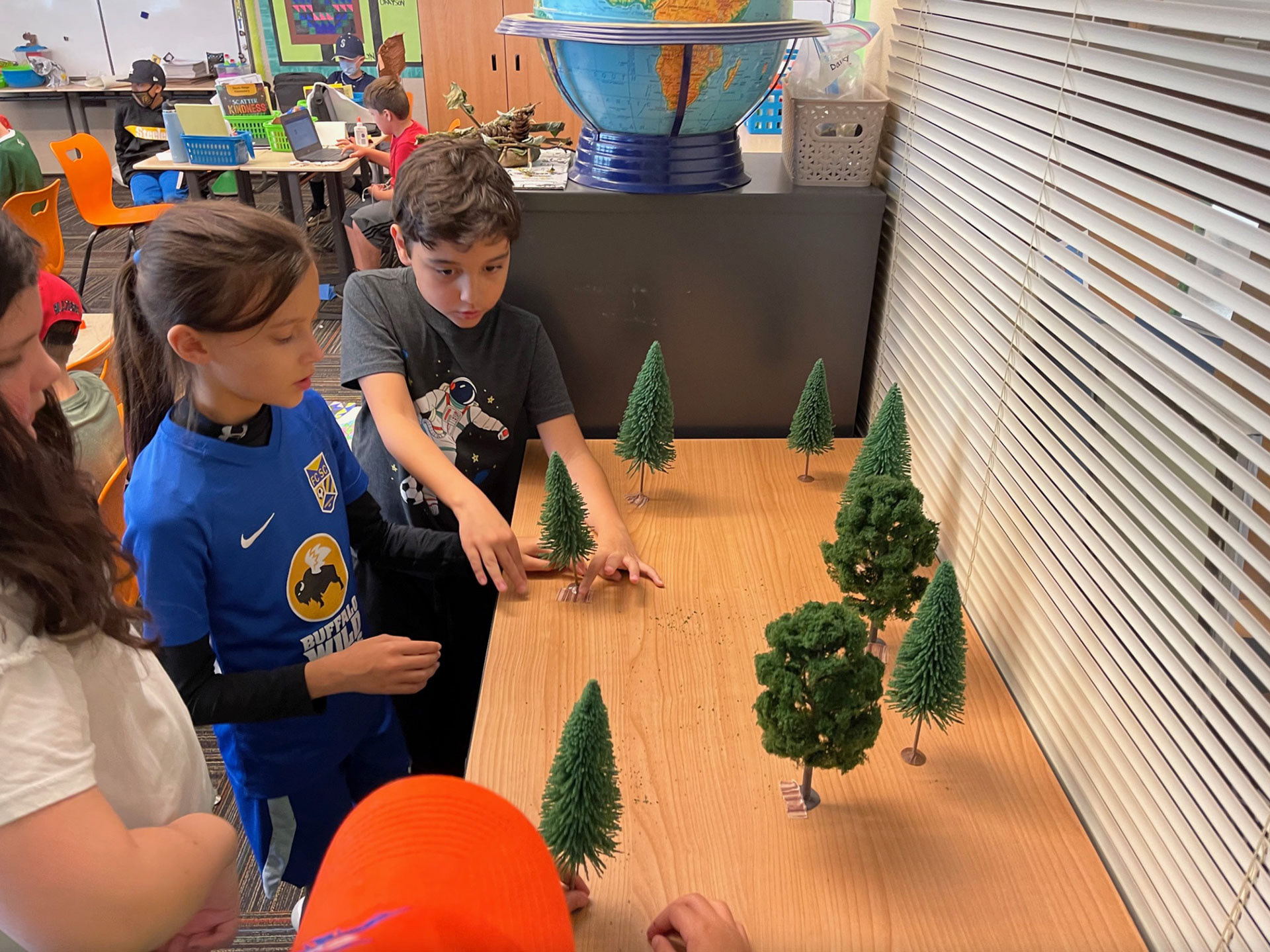 Here some kids are arranging the trees for the final diorama.