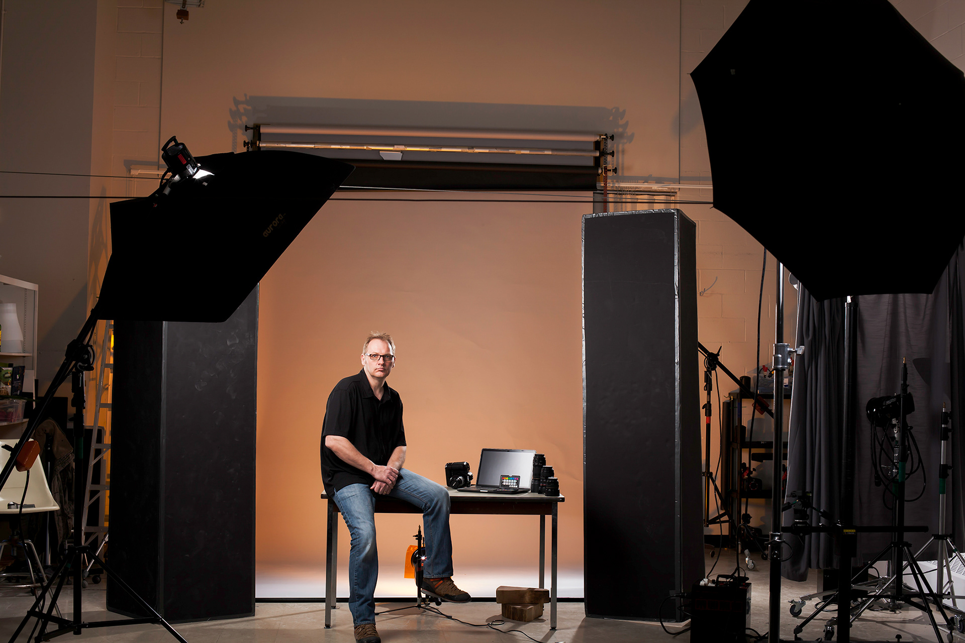 Michael Julius sitting in Fanshawe Colleges Photography Program studios