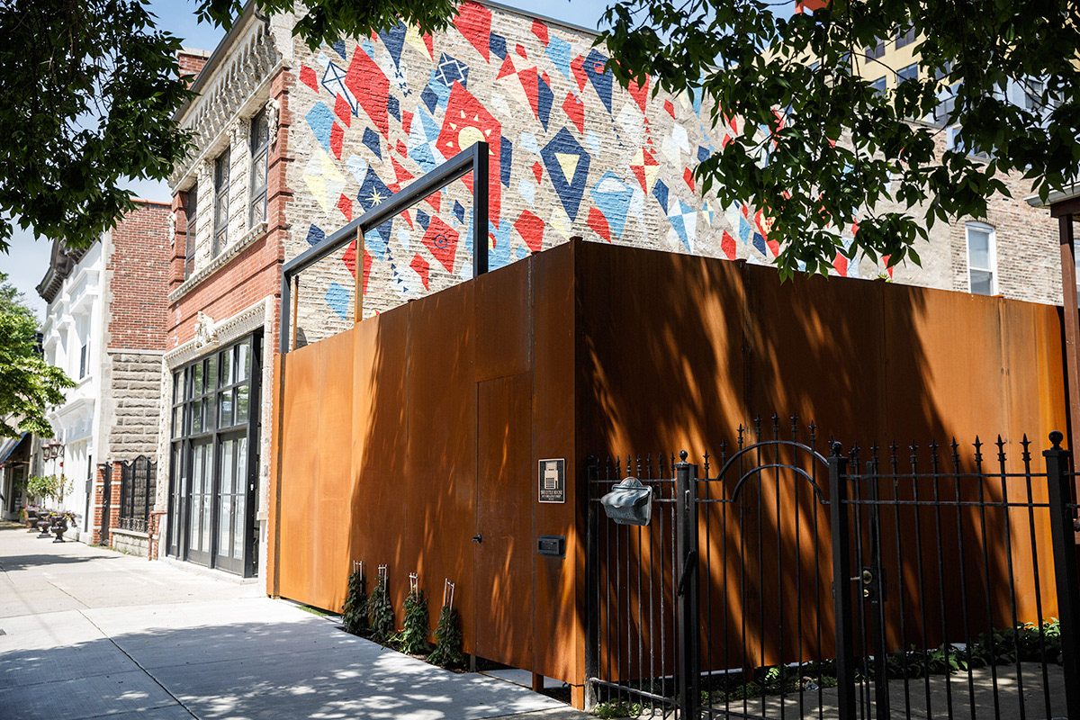 Edgewater Mural from outside, showing kites rising across side of building