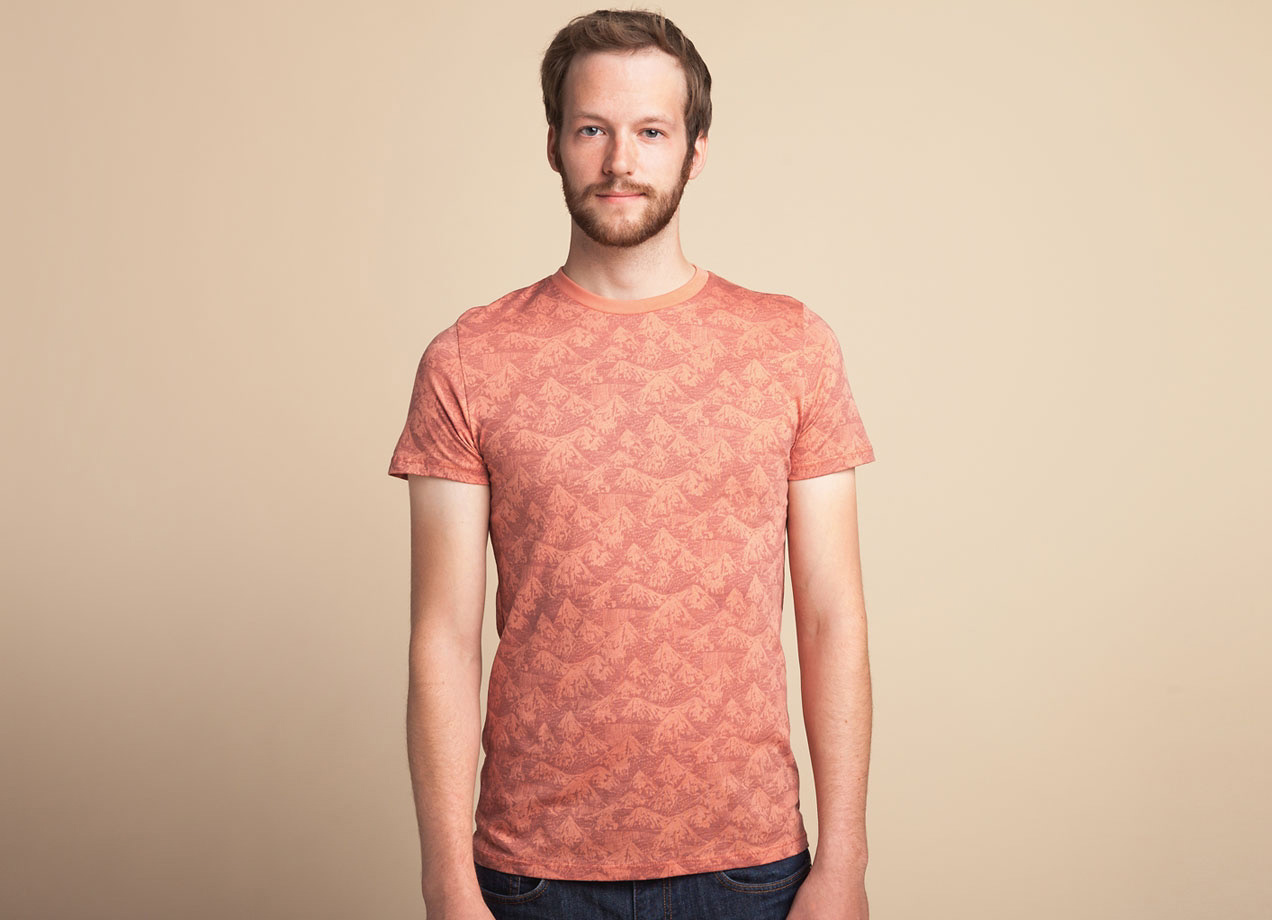 Front view of Horror Vacui surface print illustration on threadless orange t-shirt