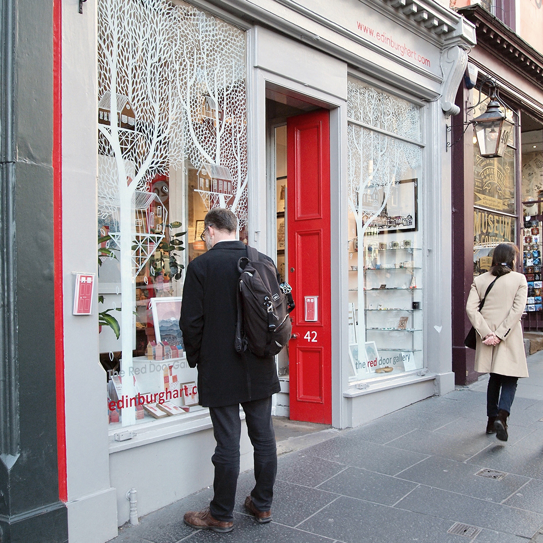 The Red Door Gallery from the outside, with hand drawn window illustrations