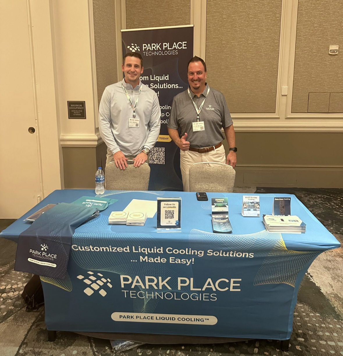 Trade show stand, using table cover, table tent, and banner designed by me.