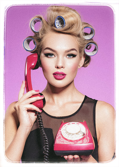 Young blonde woman with a red telephone in hands